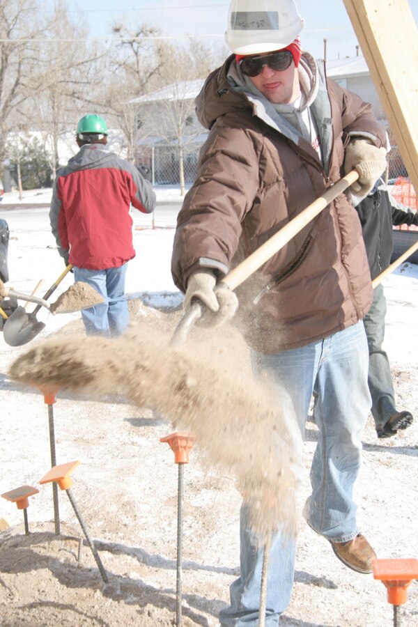 George Foelsch, poolee from RSS Metro South, levels the ground by shoveling dirt February 18, for Habitat for Humanity of Denver.