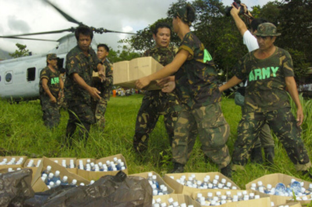 Republic of Philippines army soldiers offload food, blankets, water and other humanitarian relief supplies from a U.S. Marine CH-46E Sea Knight helicopter at Saint Bernard, Philippines, on Feb. 19, 2006. Sea Knight helicopters from Marine Medium Helicopter Squadron 262 are flying in people, supplies and equipment from the amphibious assault ship USS Essex (LHD 2) and the dock landing ship USS Harpers Ferry (LSD 49) to help victims of the Feb. 17, 2006, Guinsaugon, Philippines, mudslide disaster. 