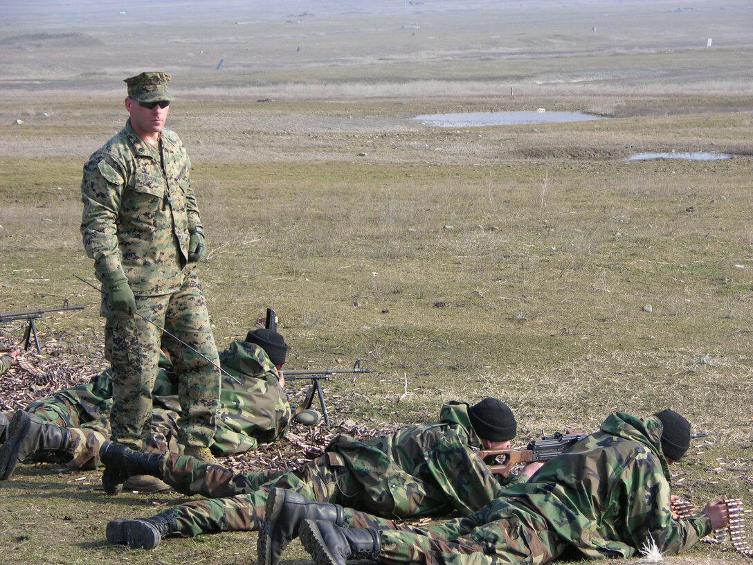 Republic of Georgia soldiers are evaluated at Krtsanisi, Republic of Georgia on their performance firing the PKM machinegun by Sgt. Michael J. Szeman, 30, (standing), a trainer with the Georgia Sustainment and Stability Operations Program and native of Matteson, Ill.  The 53-member U.S. Task Force, many of them veterans of Iraq and Afghanistan, is training the Georgian soldiers who will fill positions in Iraq. Georgia?s GSSOP trained troops will form part of the dedicated force called for in UN Security Council Resolution 1546 to protect UN forces in Iraq. The mission of the GSSOP is to assist the Georgian armed forces sustain their ongoing deployment of forces supporting stability operations in Iraq.