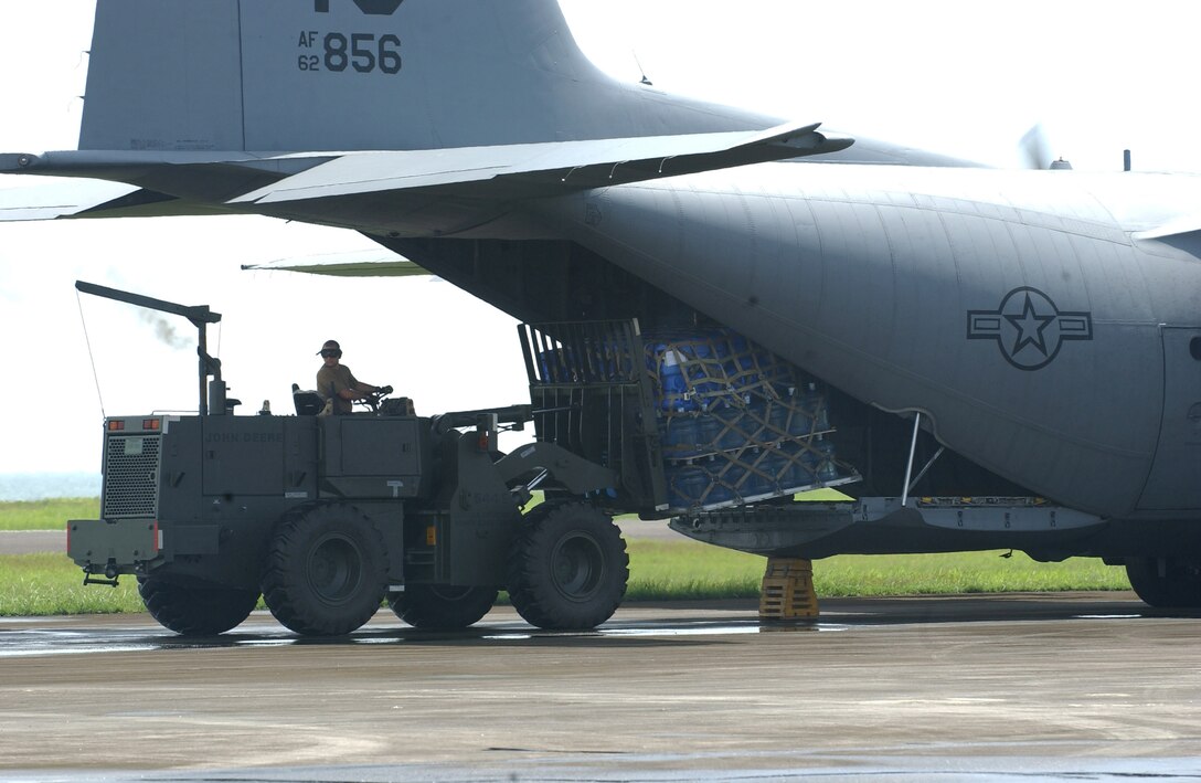 CLARK AIR BASE, Philippines (AFPN) – An Airman loads water onto a C-130 Hercules Feb. 20. Water and other relief supplies are being brought to Tacloban, a city on the northwestern part of the island of Leyte, where U.S. and Philippine armed forces are working together to help victims of the Feb. 17 landslide in the village of Guinsaugon.  (U.S. Air Force photo by Staff Sgt. Joselito Aribuabo)