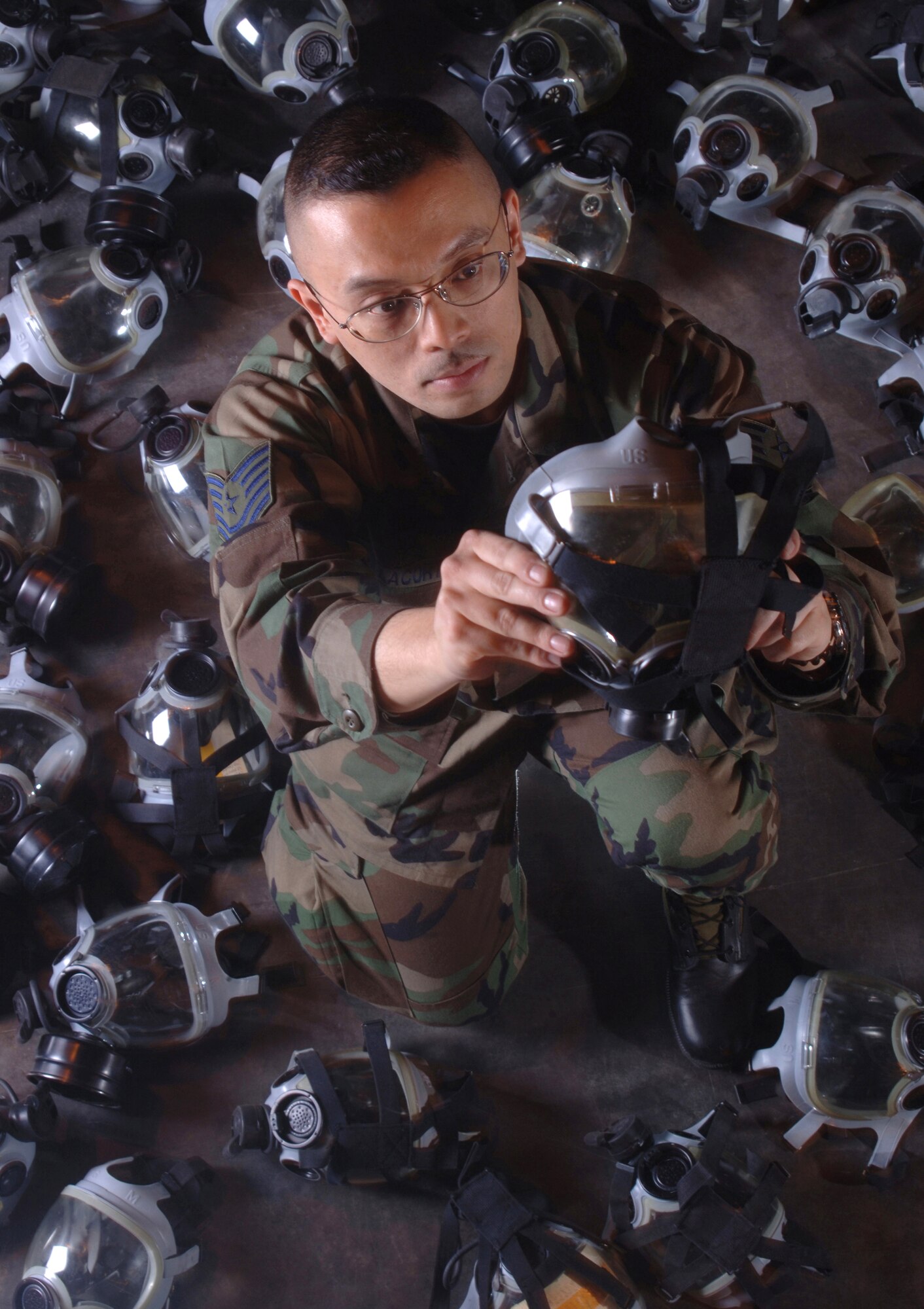 YOKOTA AIR BASE, Japan (AFPN) -- Tech. Sgt. Max Villacorta inspects gas masks for serviceability during an inventory. Sergeant Villacorta is a war readiness technician with the 374th Logistics Readiness Squadron. The squadron manages 26,000 critical supplies and equipment. (U.S. Air Force photo by Master Sgt. Val Gempis) 

