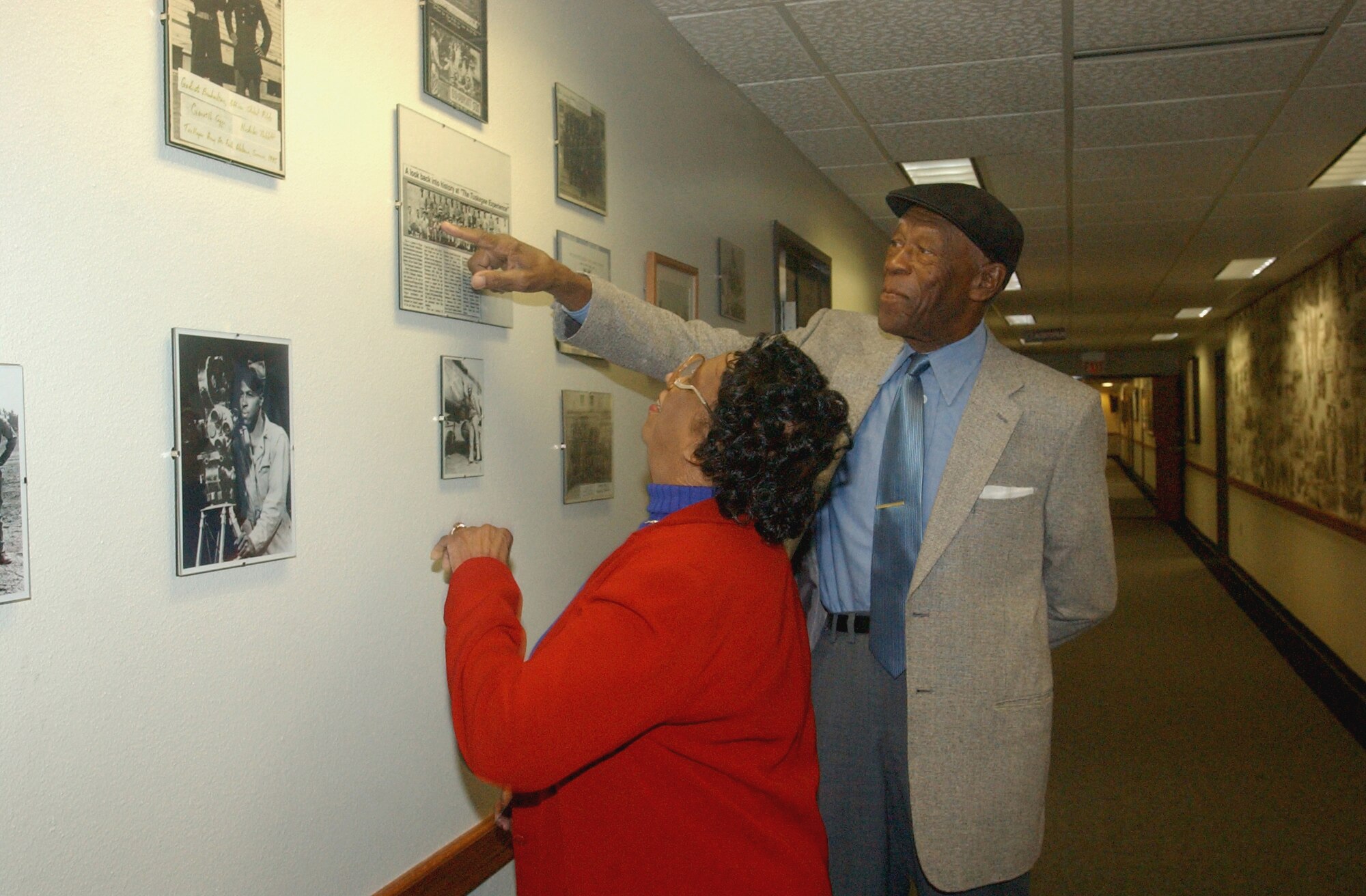RANDOLPH AIR FORCE BASE, Texas (AFPN) -- John Miles shows his friend Mildred Jones a photo he is in at the 99th Flying Training Squadron. He recently visited the unit he was assigned to in the 1940s. (U.S. Air Force photo by Staff Sgt. Lindsey Maurice) 

