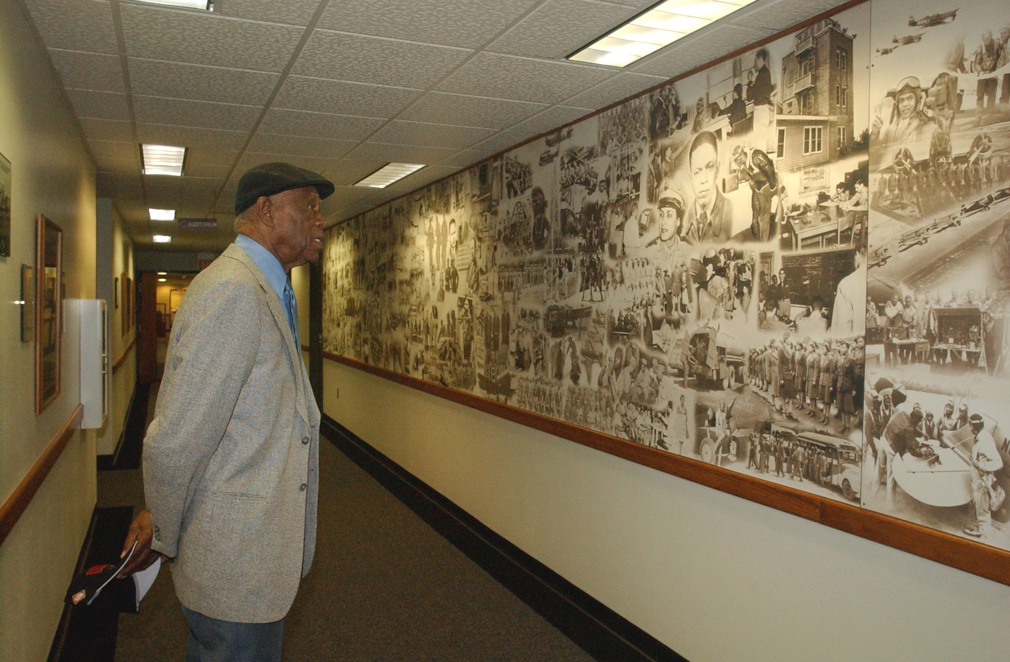 RANDOLPH AIR FORCE BASE, Texas (AFPN) -- John Miles looks at the Tuskegee Airmen heritage wall at the 99th Flying Training Squadron. He recently visited the unit he was assigned to in the 1940s. (U.S. Air Force photo by Staff Sgt. Lindsey Maurice) 


