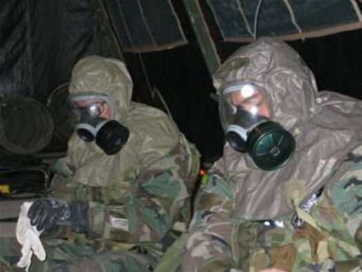 Hurlburt Field Fla. -- Two 823rd RED HORSE Squadron Airmen put on their nuclear, biological and chemical gear as part of an alarm condition red during the squadron's operational readiness inspection redo recently. The 823rd RHS earned a satisfactory rating.