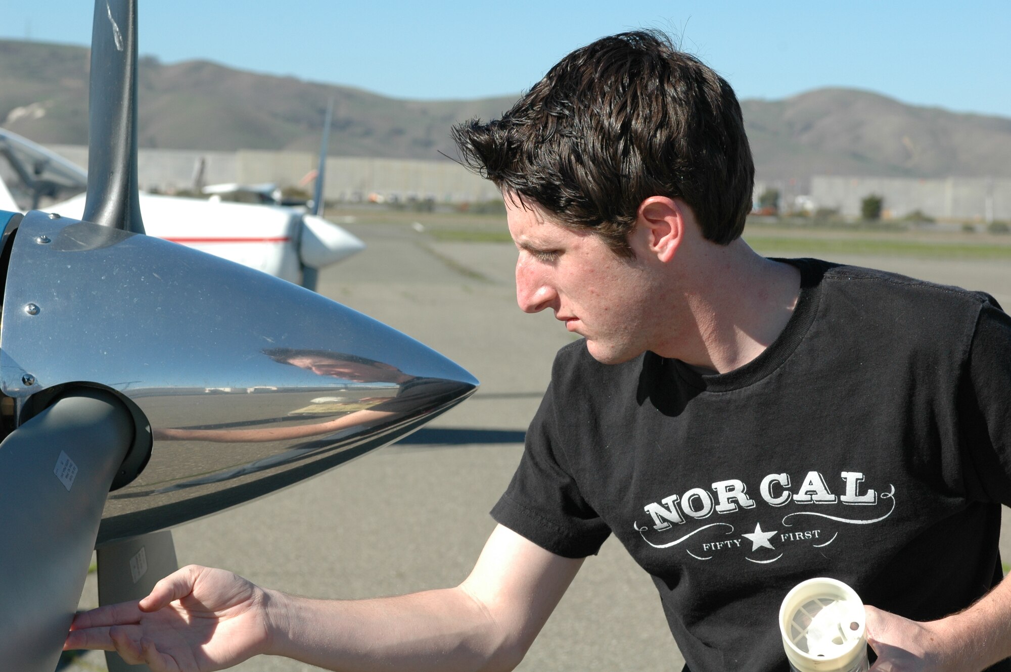 Mr. Chris Lathem, aero club member, inspects his aircraft before flying at the Travis Aero Club.  He is one of many aero club members that will benefit from a new fleet of aircraft operating at a new off-base location. (U.S. Air Force photo by Capt. Vanessa Hillman)
