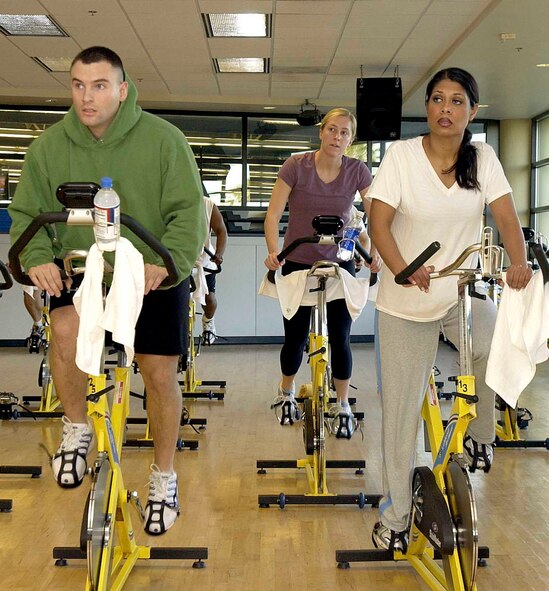 Anthony Sibilia and his wife, Marisa Sibilia, work out together during the Valentine's Day Aerobathon Monday. Being physically active for 30 to 60 minutes a day can help people lower their blood pressure, reduce cholesterol levels and maintain a healthy weight. (U.S. Air Force photo by Andre Mansour)