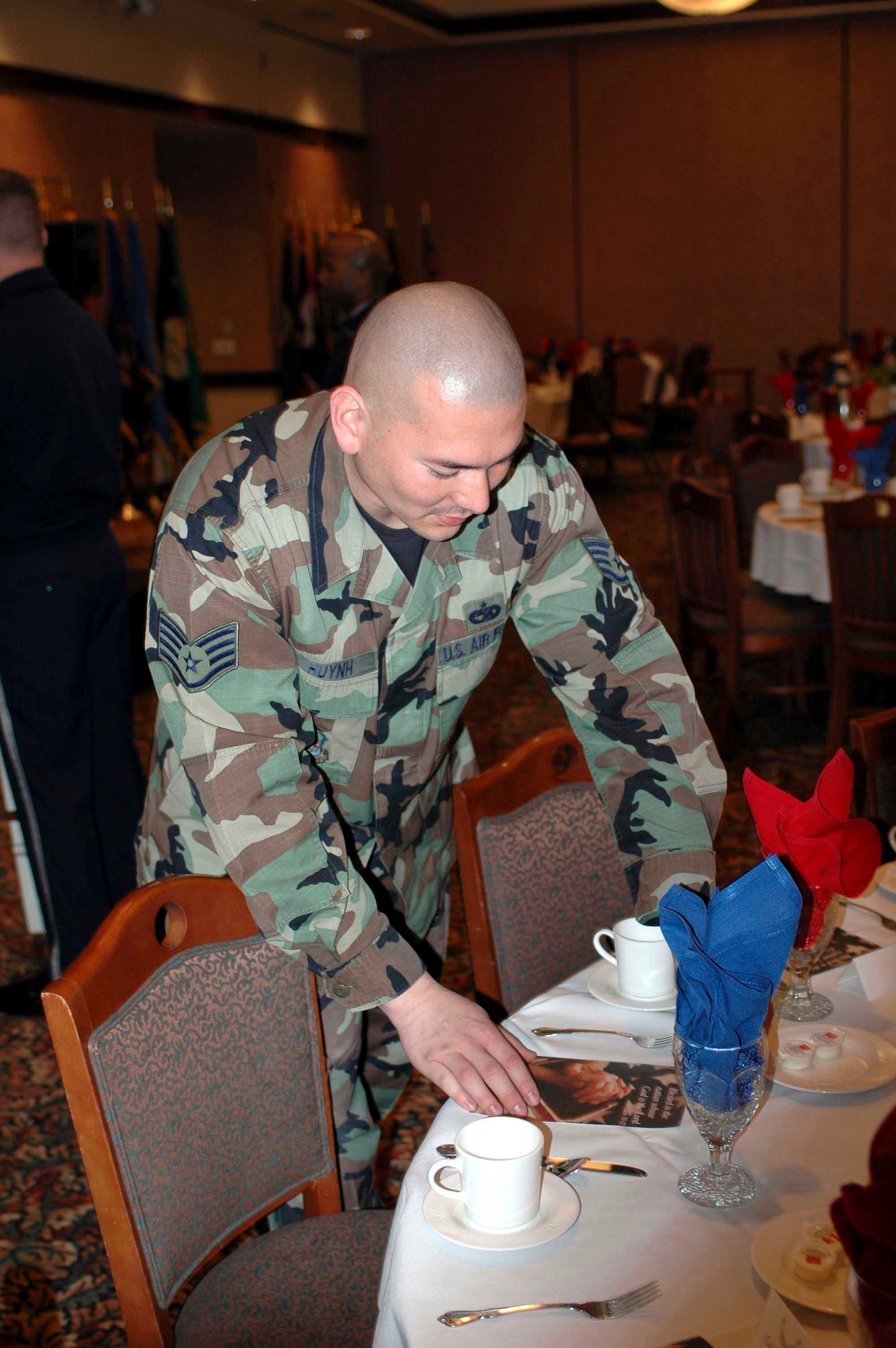 Staff Sgt. Chi Huynh, 60th Air Mobility Wing protocol, prepares seating arrangement for the National Prayer luncheon Feb. 7. (U.S. Air Force photo by Staff Sgt. Matt McGovern)