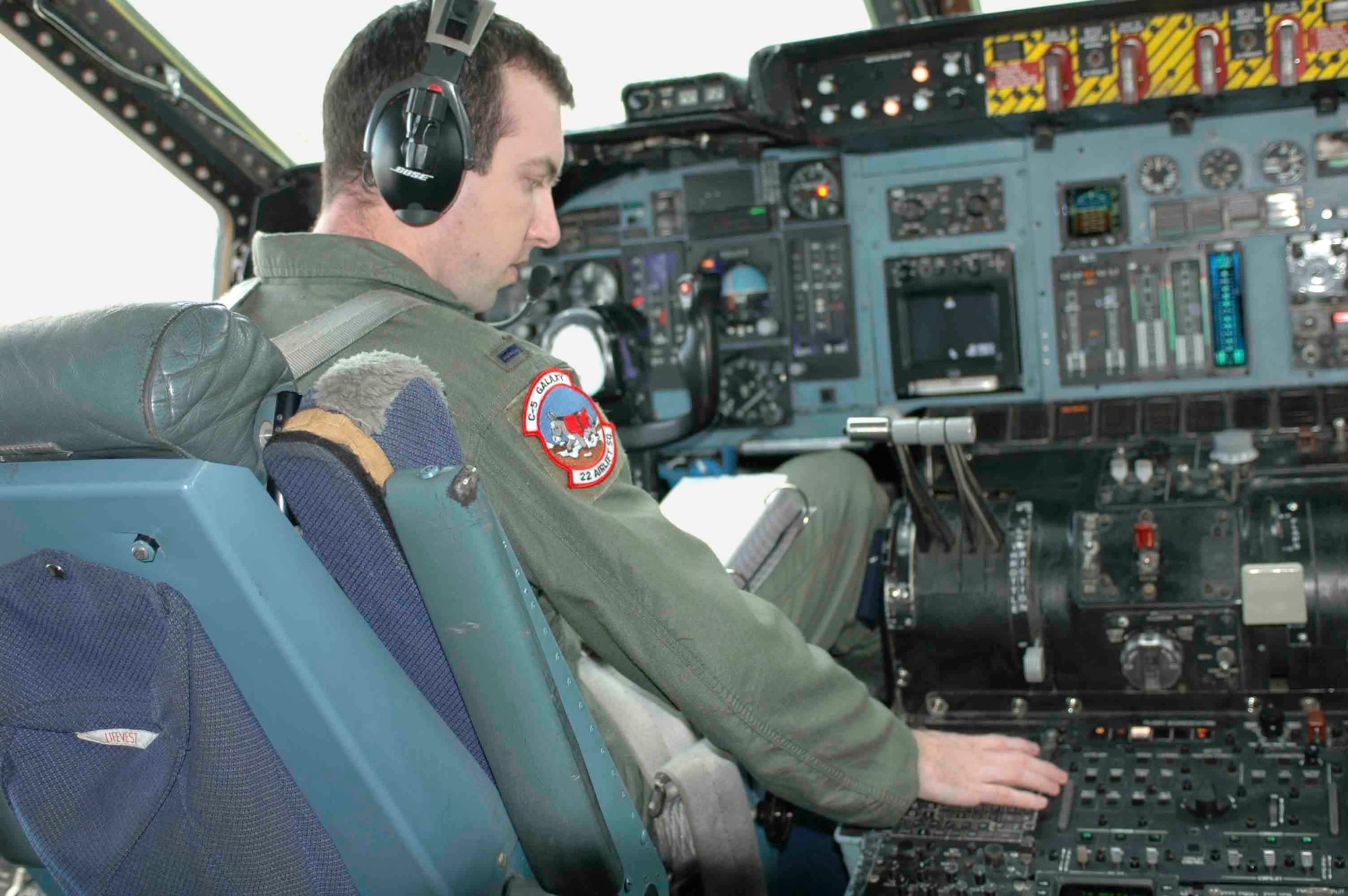 1st Lt. Bryan Foley, 22nd Airlift Squadron pilot, sets up his navigational aids and radios prior to taxiing out during his checkride Feb. 3. Lieutenant Foley was the last active-duty C-5 co-pilot to upgrade. Travis is one of two active C-5 bases; the other is Dover Air Force Base, Del. (U.S. Air Force photo by Airman 1st Class Tiffany Low)