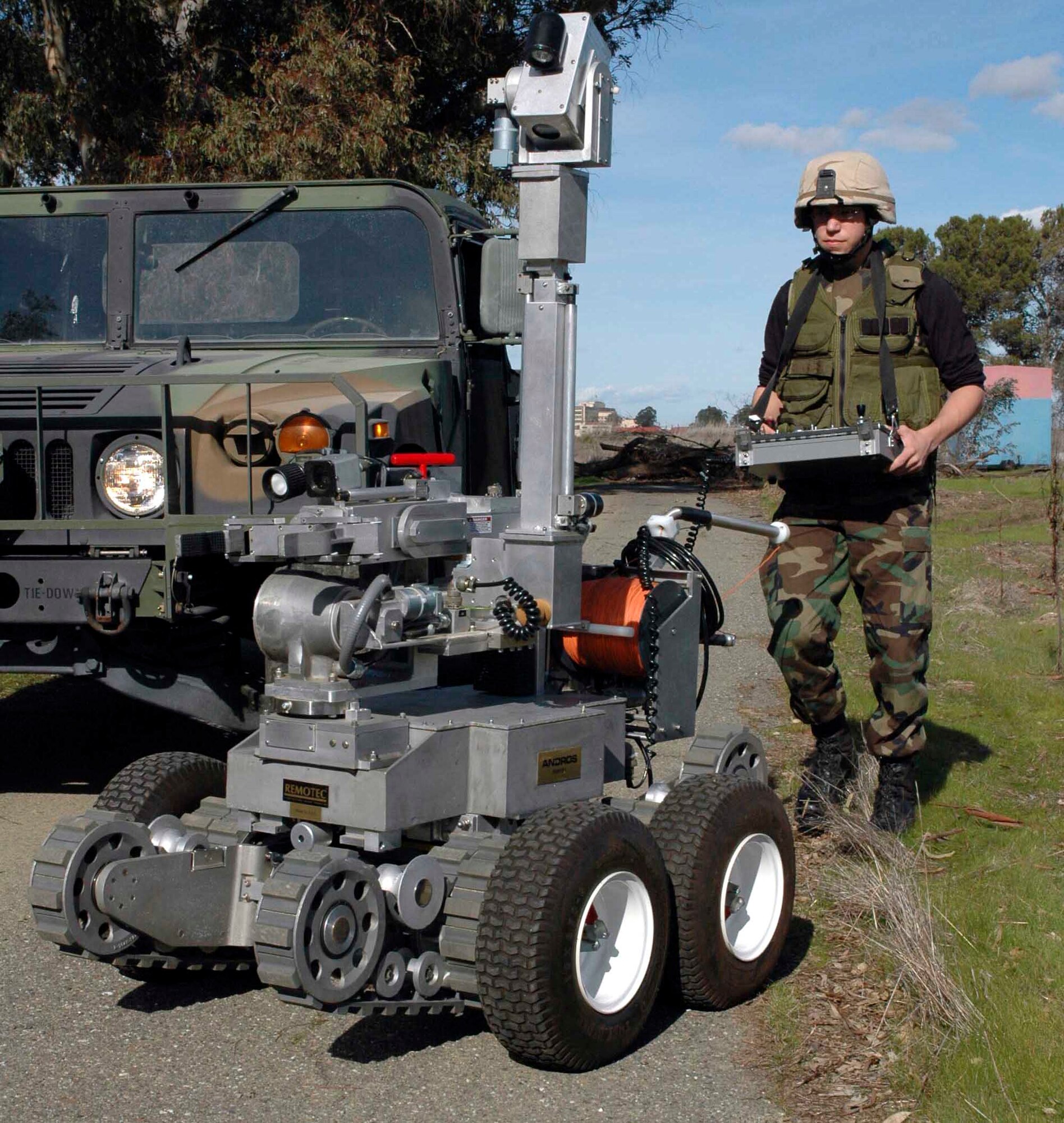 Airman 1st Class Mason Messick, 60th Civil Engineer Squadron explosive ordnance disposal apprentice, guides the Remotec F6A Remote Control Transport robot to a simulated improvised explosive device during field training. (U.S. Air Force photo by Staff Sgt. Matt McGovern)
