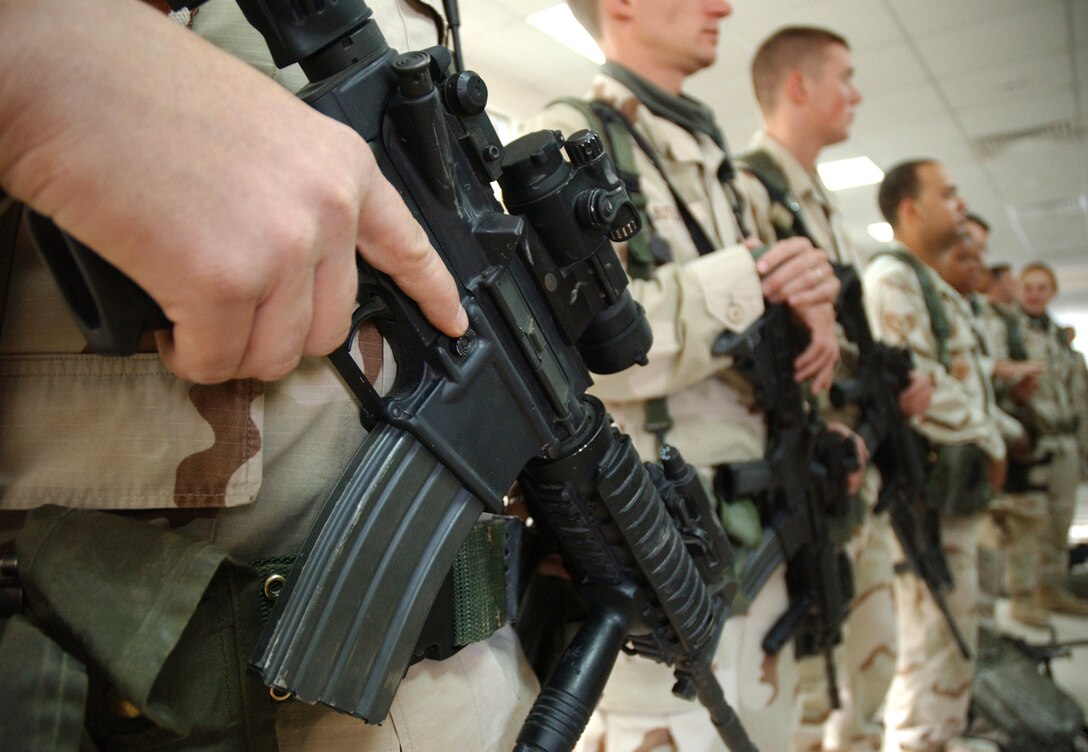 SOUTHWEST ASIA (AFPN) -- Security forces Airmen stand at ease during a guard mount call at a deployed location Feb. 19. The Airmen are with the 379th Expeditionary Security Forces Squadron. (U.S. Air Force photo by Airman 1st Class Anthony Nelson Jr.)