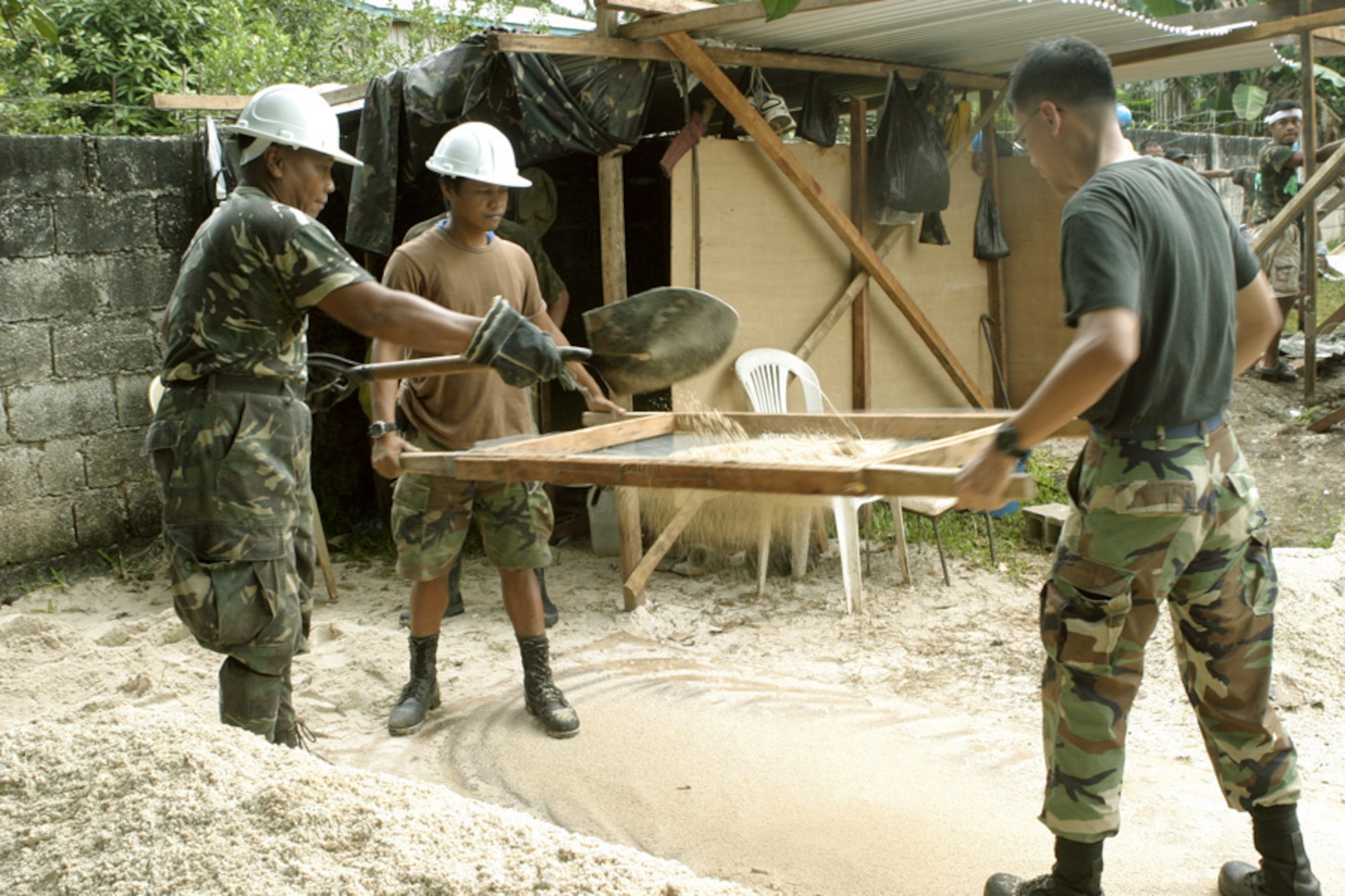 JOLO, Philippines (AFPN) -- Armed Forces of the Philippines engineers and an Airman work at the construction site of a three-room school, an addition to the existing Sulu High School, Feb. 20. This is one of several civil action programs taking place during Exercise Balikatan 2006. (U.S. Marine Corps photo by Sgt. Jason L. Jensen)