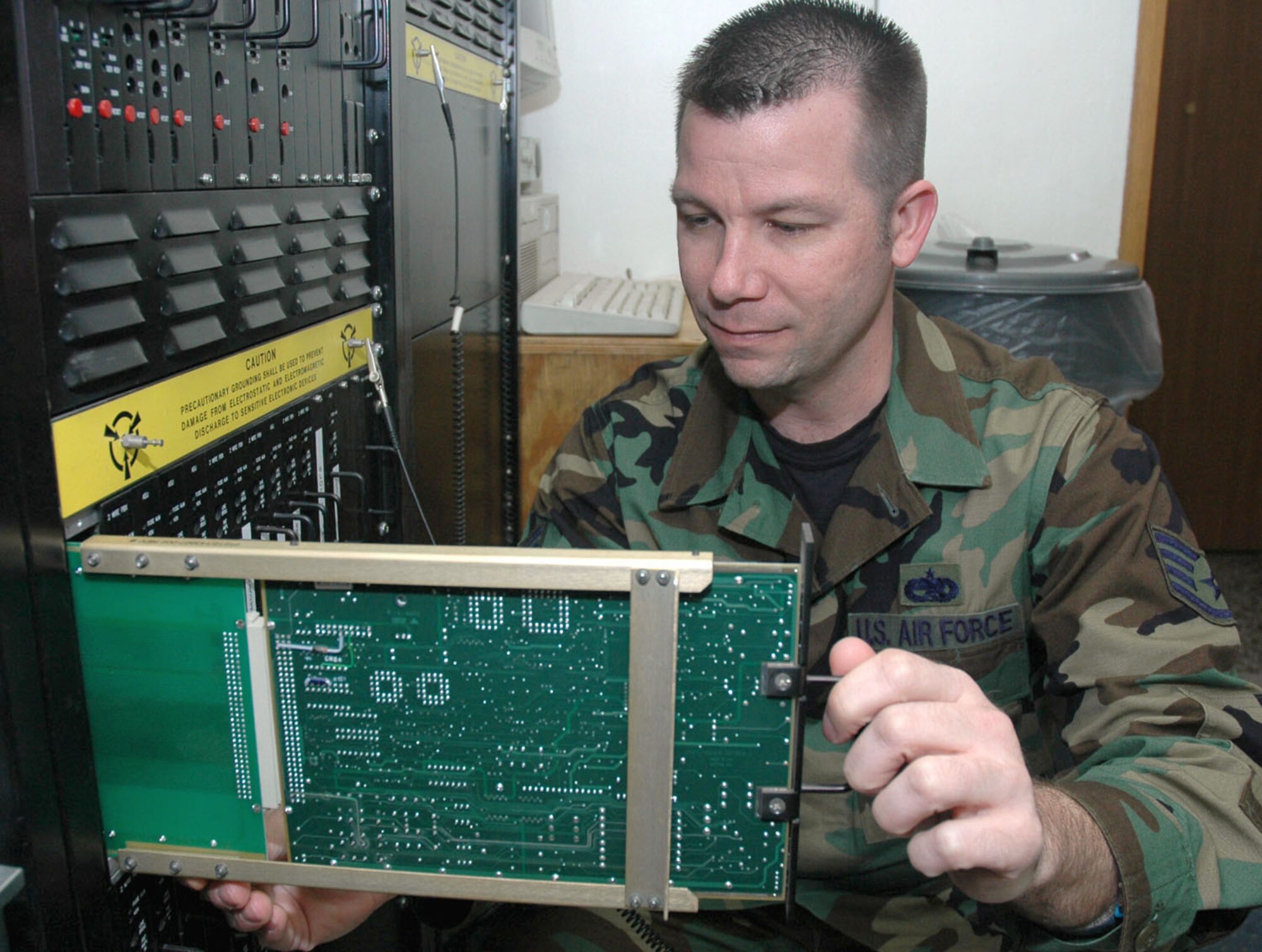 TUZLA AIR BASE, Bosnia and Herzegovina (AFPN) -- Staff Sgt. Mark Beecroft aligns a telephone card while performing an annual certification on air traffic control and landing systems. He is assigned to the 401st Air Expeditionary Wing. (U.S. Air Force photo by Master Sgt. Chance Babin)