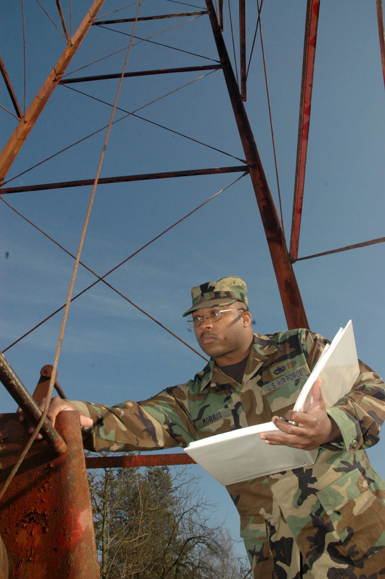 TUZLA AIR BASE, Bosnia and Herzegovina (AFPN) -- Staff Sgt. Mario Morris inspects the harness of an antenna cable system for corrosion. He is assigned to the 401st Air Expeditionary Wing. (U.S. Air Force photo by Master Sgt. Chance Babin)


