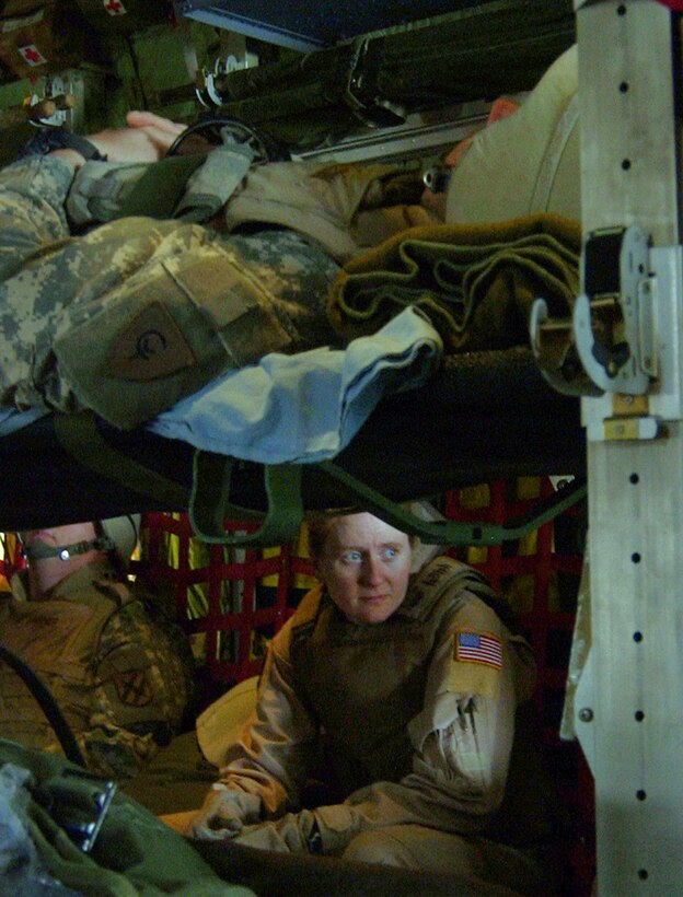 MOSUL, Iraq (AFPN) -- After loading patients, Tech. Sgt. Amy Romanas takes a brief break. "We always hope we won't be busy, but if someone does get hurt, we're ready to give them the care that they need," she said. Sergeant Romanas is a medical technician with the 379th Expeditionary Aeromedical Evacuation Squadron. (U.S. Air Force photo by Staff Sgt. Melissa Koskovich)