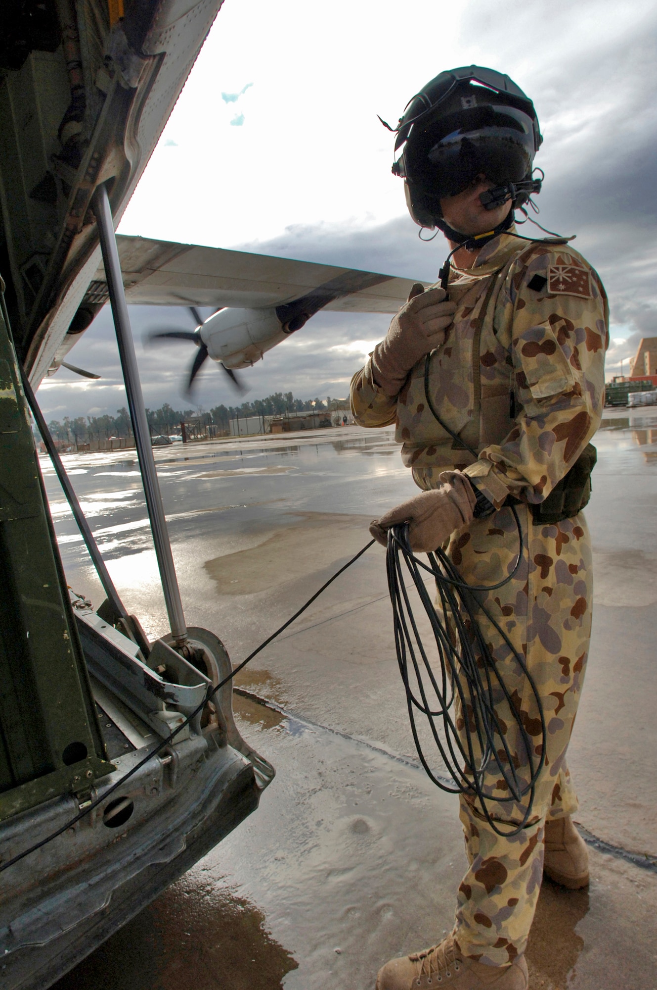 MOSUL, Iraq (AFPN) -- Royal Australian Air Force Sgt. Errol Taylor monitors loading operations of the "mercy channel" flight Feb. 15. The RAAF unit flies a weekly mercy mission throughout Iraq and Kuwait, gathering wounded servicemembers and taking them to higher echelons of care. Sergeant Taylor is from the 37 Squadron based out of RAAF Base Richmond, New South Wales, Australia. (U.S. Air Force photo by Master Sgt. Lance Cheung)