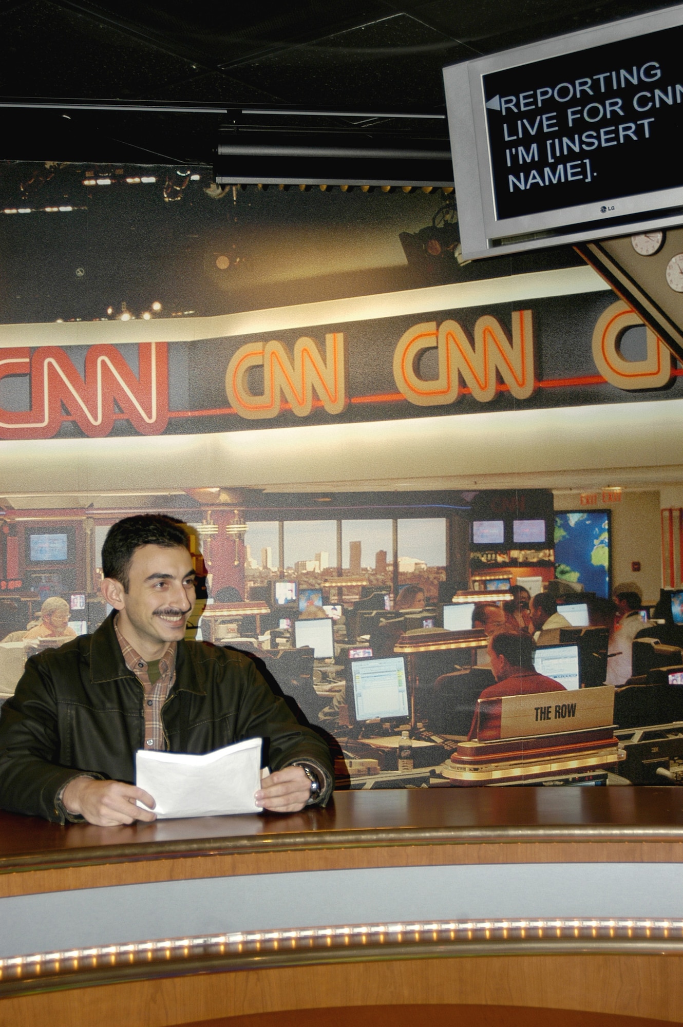 ATLANTA (AFPN) -- Second Lt. Nuno Goulart of Portugal gets acquainted with a mock news anchor desk at CNN Headquarters Feb. 18. Lieutenant Goulart is in pilot training at Columbus Air Force Base, Miss. (U.S. Air Force photo by Senior Airman Cecilia Rodriguez)

