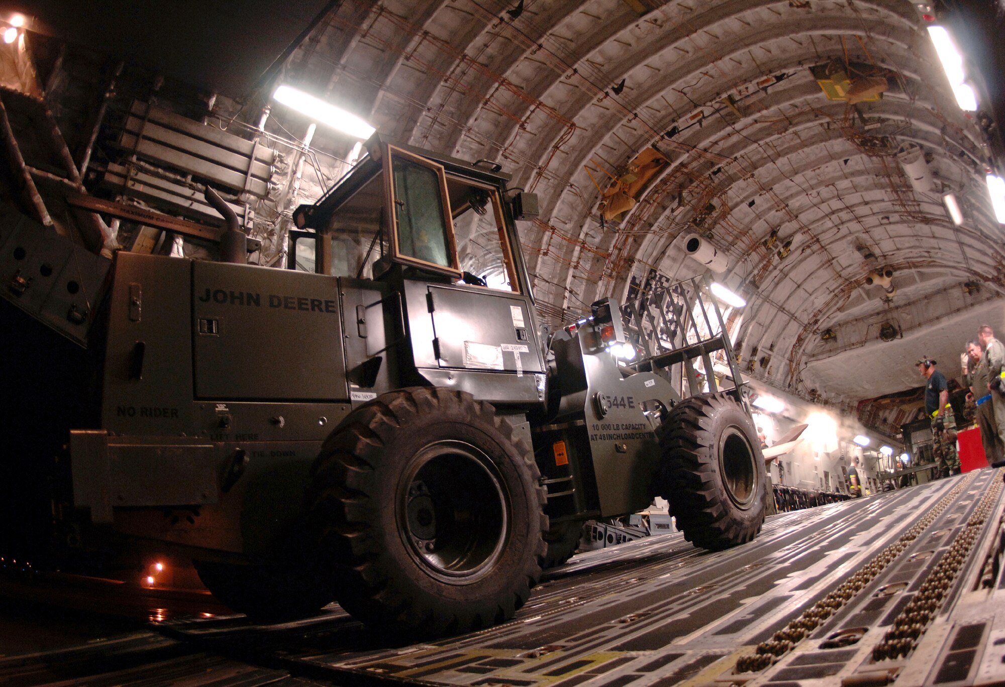 ANDERSEN AIR FORCE BASE, GUAM (AFPN) -- Airmen with the 734th Air Mobility Squadron load a forklift onto a C-17 Globemaster III. The C17 is assigned to the 535th Airlift Squadron from Hickam Air Force Base, Hawaii.  Heavy equipment, food and water supplies were transported Feb. 22 to the Philippines in the aftermath of the mudslides on Leyte Island.  (U.S. Air Force photo by Staff Sgt. Bennie J. Davis III)