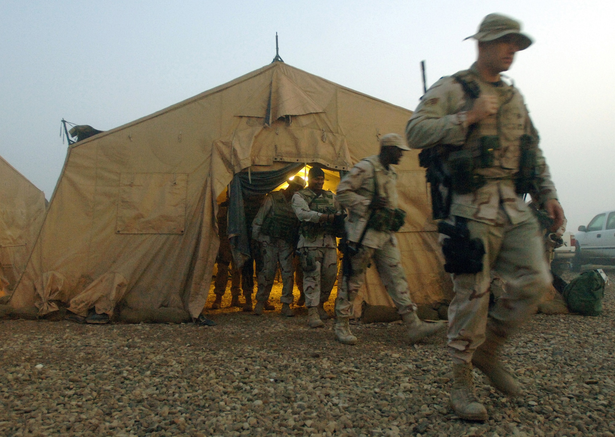 ALI BASE, Iraq (AFPN) -- Airmen depart geared up and ready to relieve the night shift after being briefed on current conditions Feb 16. The Airmen are with the 407th Expeditionary Security Forces Squadron. (U.S. Air Force photo by Staff Sgt. Valerie Smith) 