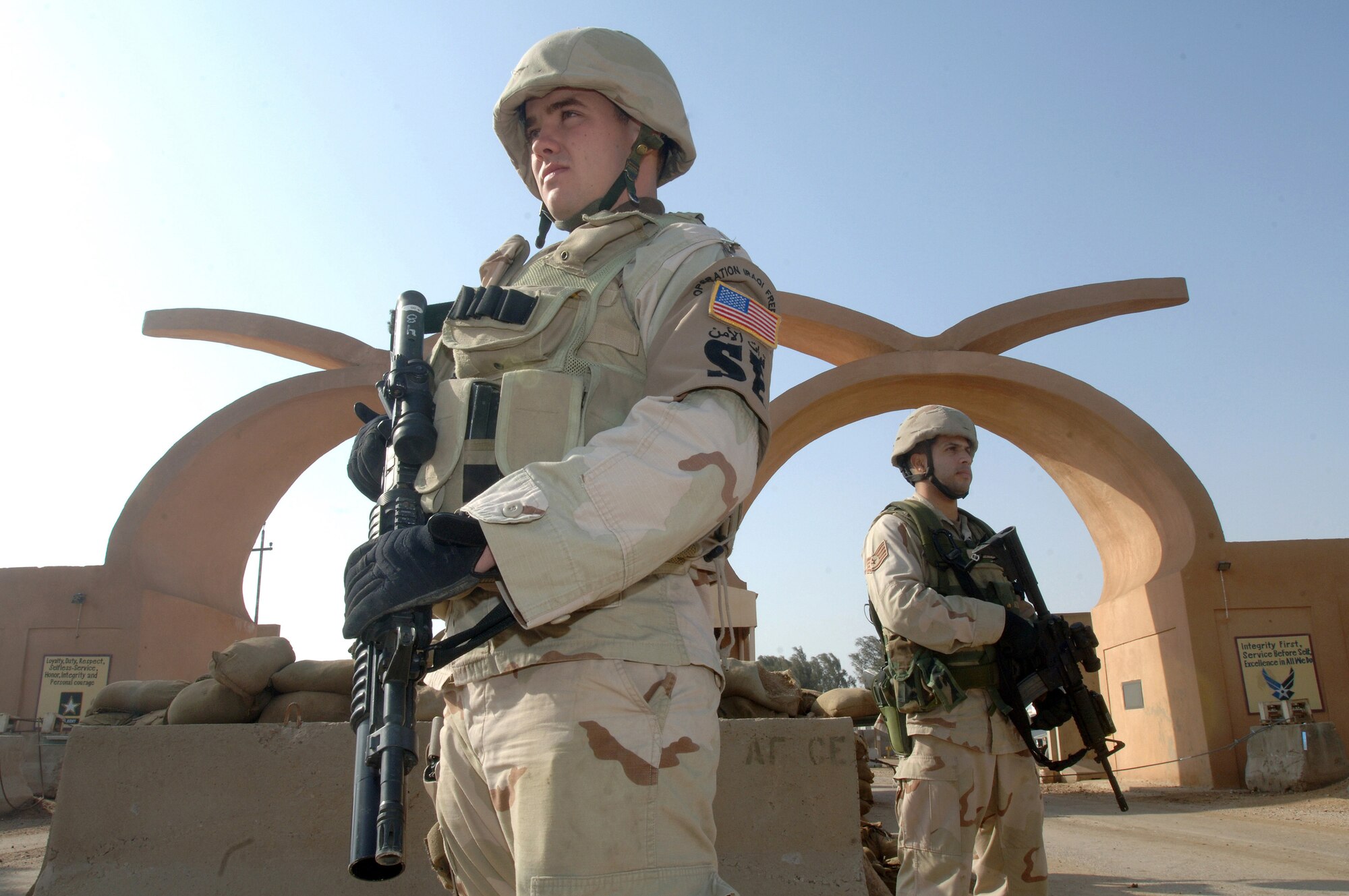 ALI BASE, Iraq (AFPN) -- Airman 1st Class Joshua Williams (left) and Staff Sgt. Marcus Serrano are ready to check ID cards at a base control point Feb. 16. The Airmen are with the 407th Expeditionary Security Forces Squadron. (U.S. Air Force photo by Staff Sgt. Valerie Smith) 