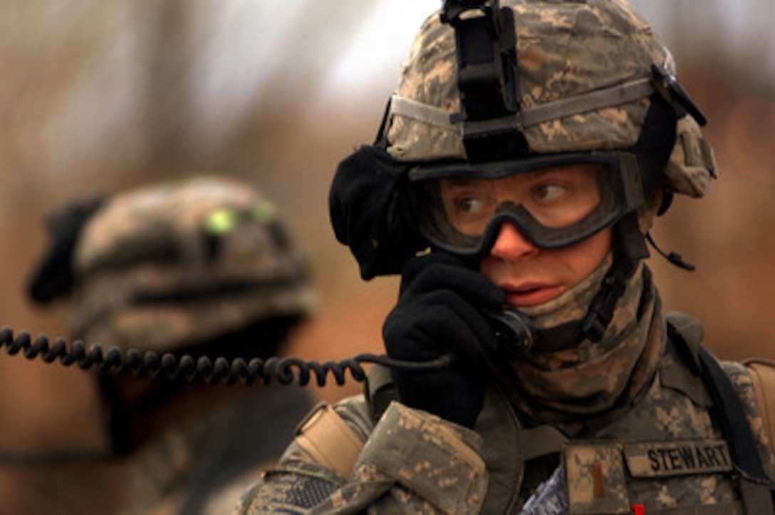 Army 2nd Lt. Dustin Stewart checks in by radio as his unit conducts a combat patrol of the streets in Tall Afar, Iraq, on Feb. 20, 2006. Stewart is attached to the 1st Armored Division. 