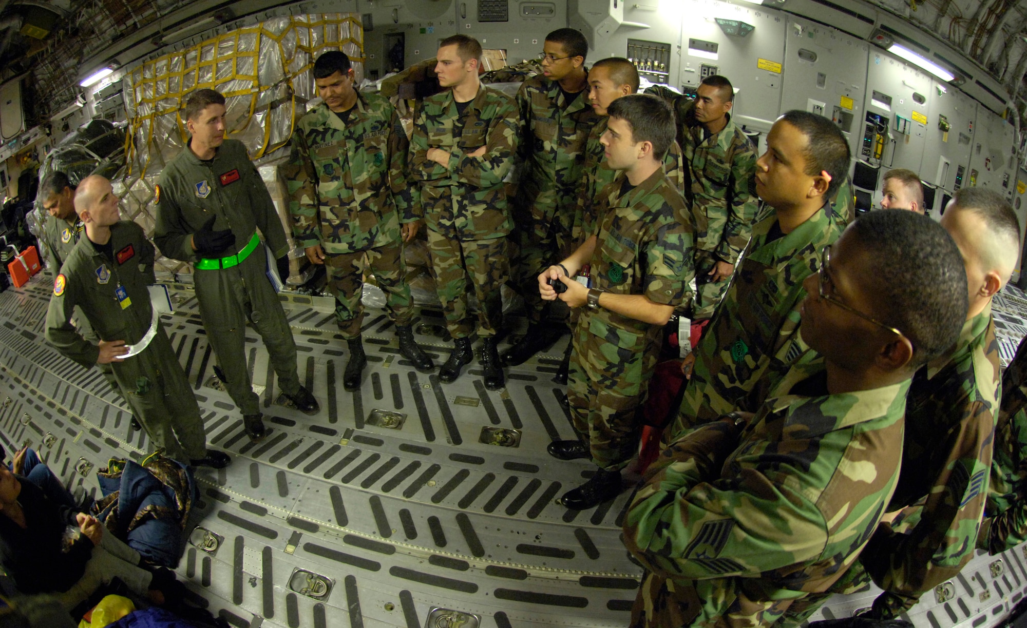 HICKAM AIR FORCE BASE, Hawaii (AFPN) -- Tech. Sgt. Ken Bragg and Staff Sgt. Ryan Page give a safety briefing aboard a C-17 Globemaster III to members of the 15th Airlift Wing before a mission to the Philippines. The 535th Airlift Squadron and the 204th Airlift Squadron conducted the first contingency response mission to support relief efforts in the Philippines. Both sergeants are with the 535th Airlift Squadron. (U.S. Air Force photo by Tech. Sgt. Shane A. Cuomo) 