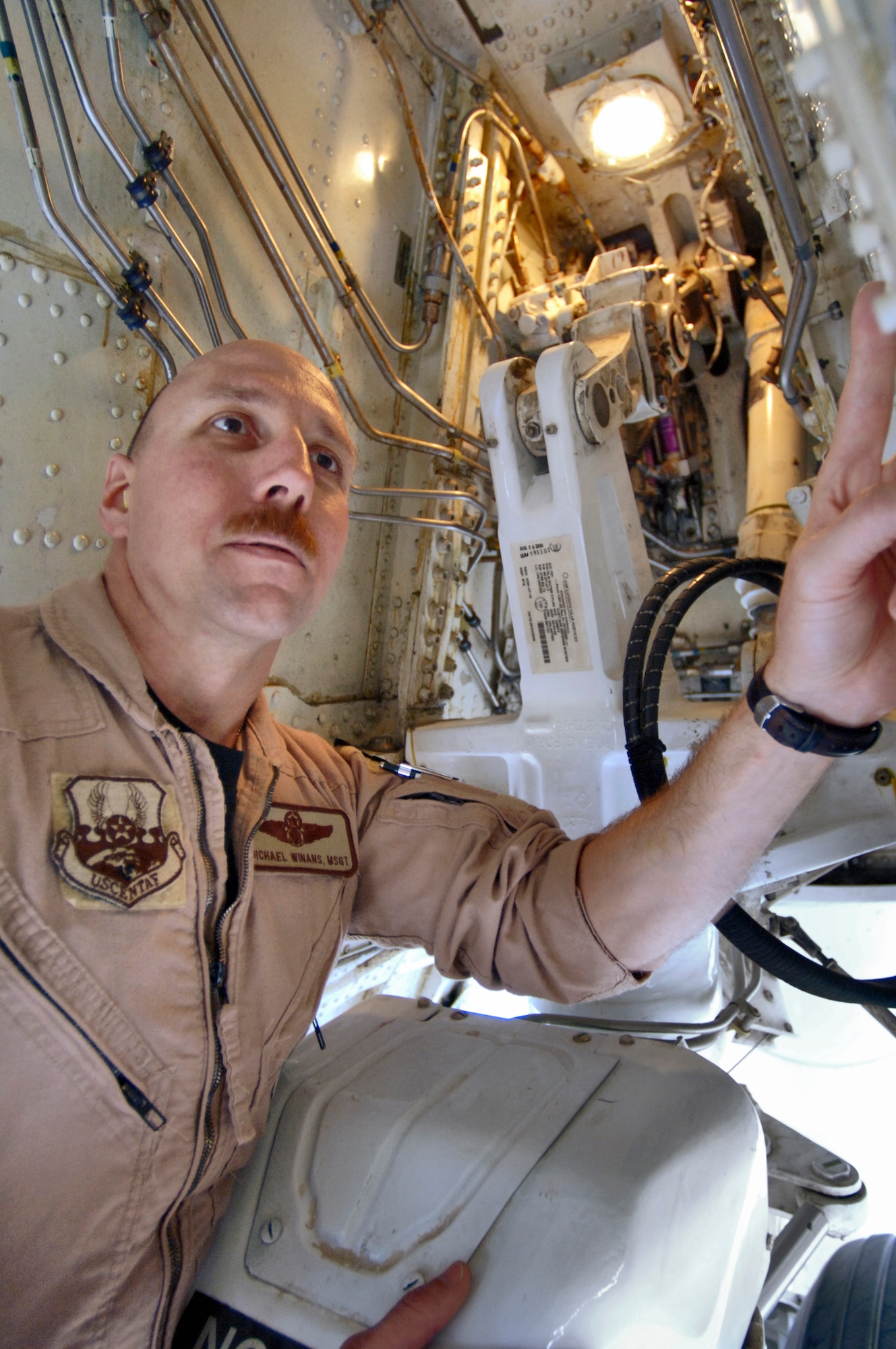 SOUTHWEST ASIA (AFPN) -- Master Sgt. Michael Winans checks the nose gear wheel bearing cap during his pre-flight inspection of an E-8C Joint Surveillance and Target Attack Radar System aircraft. Joint STARS provides command and control, intelligence, surveillance and reconnaissance. The E-8C is assigned to the 12th Expeditionary Airborne Command and Control Squadron. Sergeant Winans is a flight engineer with the 116th Air Control Wing, Robins Air Force Base, Ga. (U.S. Air Force photo by Master Sgt. Lance Cheung) 