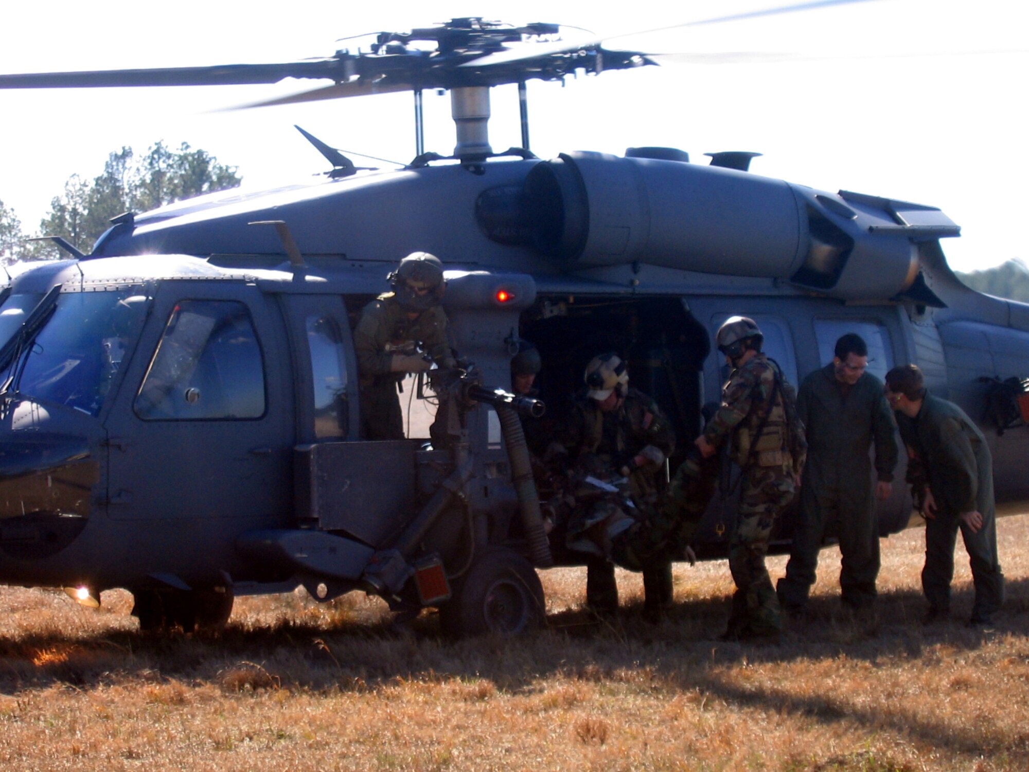 MOODY AIR FORCE BASE, Ga. - A survivor is loaded into a 41st Rescue Squadron HH-60G Pave Hawk during a combat search and rescue scenario Feb. 16 at the Bemis Range, here, as part of the Moody “War”. The four-day exercise tested the coordination sklls between Moody’s CSAR units and additional support assets. (Photo by 1st Lt. Dustin Hart)