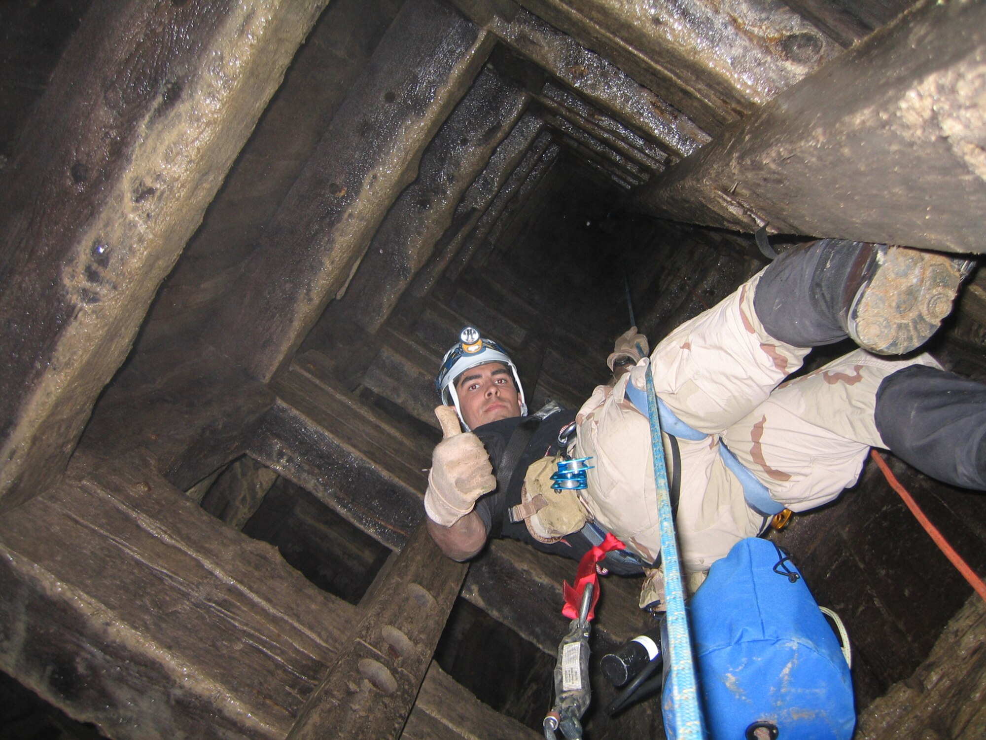 BUTTE, Mont. - Senior Airman Mark Houghton, a 38th Rescue Squadron pararescueman from Moody Air Force Base, Ga., rappels down a mineshaft during high-altitude training here. The 38th RQS conducts the training in preparation for future search and rescue missions. (Courtesy photo)                         