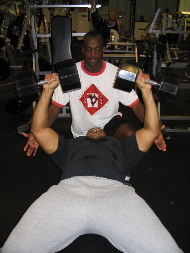 MOODY AIR FORCE BASE, Ga. - Senior Master Sgt. Frederick Thomas spots Tech. Sgt. Tommy Reid, both from the 347th Medical Group here, at the Freedom I Fitness Center Feb. 7. They began working out together after finding out they both had high cholesterol, and the best way to combat cholesterol is with proper exercise and diet. (Photo by Senior Airman S.I. Fielder)