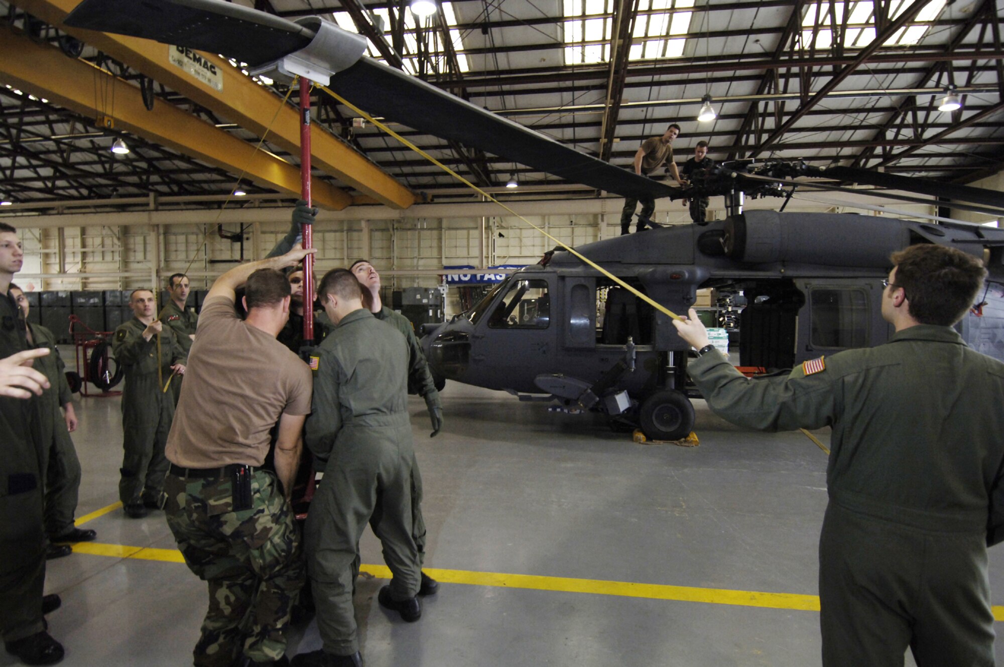 MOODY AIR FORCE BASE, Ga. -- Aircrew members from the 41st Rescue Squadron, here, learn specific operations for unfolding the main rotor blades of an HH-60G Pave Hawk from members of the 347th Aircraft Maintenance Squadron. This team effort will allow the crews rapidly deploy the helicopters. (Photo by Staff Sgt. Manuel Martinez)