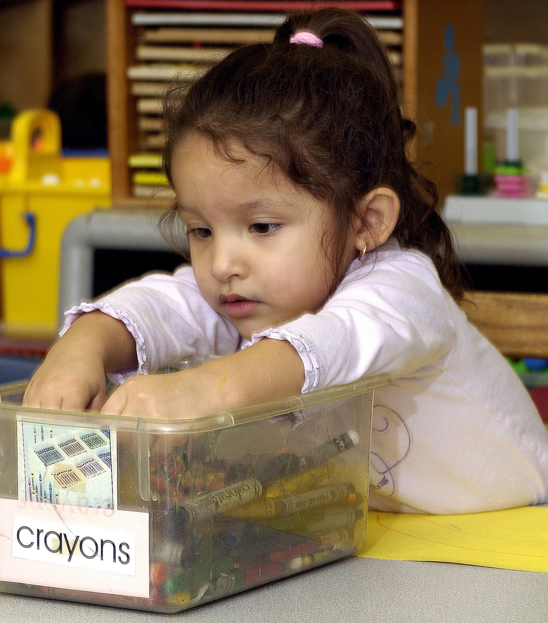 KEESLER AIR FORCE BASE, Miss. (AFPN) -- Emily Guinn, 3, reaches for a marker to start coloring in her drawing from Hurricane Katrina at the child development center Feb. 21. The children's drawings are displayed throughout the center as a means for them to express their feelings about the hurricane. Emily's father is Juan Guinn. (U.S. Air Force photo by Tech. Sgt. Larry A. Simmons) 