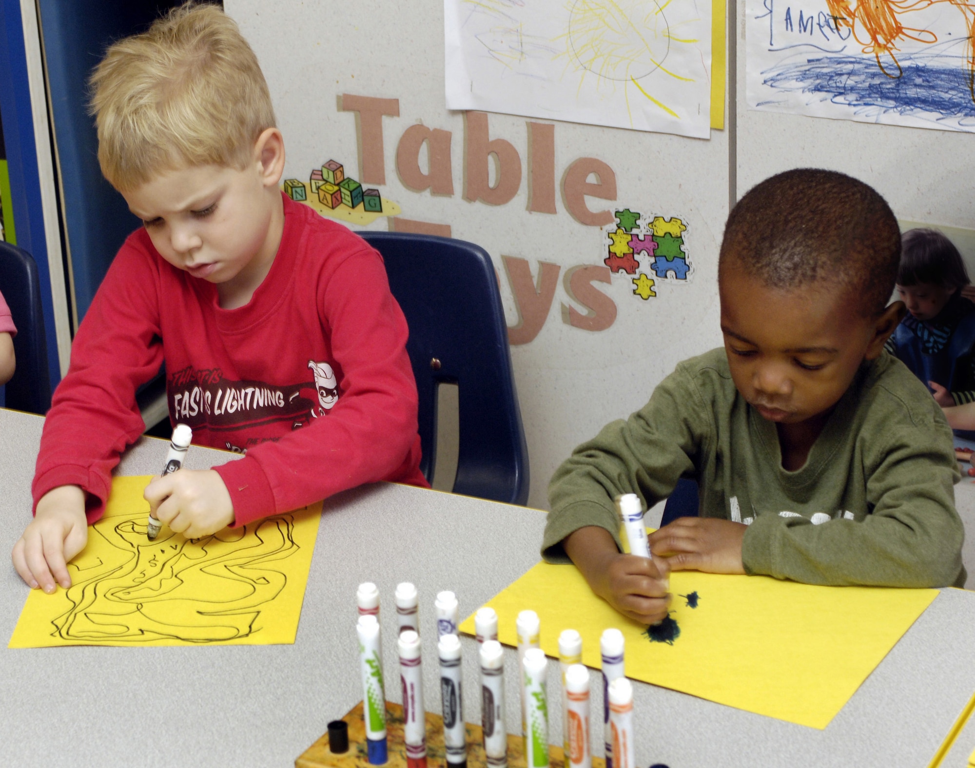 KEESLER AIR FORCE BASE, Miss. (AFPN) -- Brantly Shows, 4, and Damian Dixon, 3, draw pictures of devastation from Hurricane Katrina at the child development center Feb. 21. The children's drawings are displayed throughout the center as a means for them to express their feelings about the hurricane. Brantly's father is Staff Sgt. Alexander Shows of the 85th Engineer Squadron and Damian's mother is Tech. Sgt. Carmaneta Dixon of the mission support squadron. (U.S. Air Force photo by Tech. Sgt. Larry A. Simmons) 