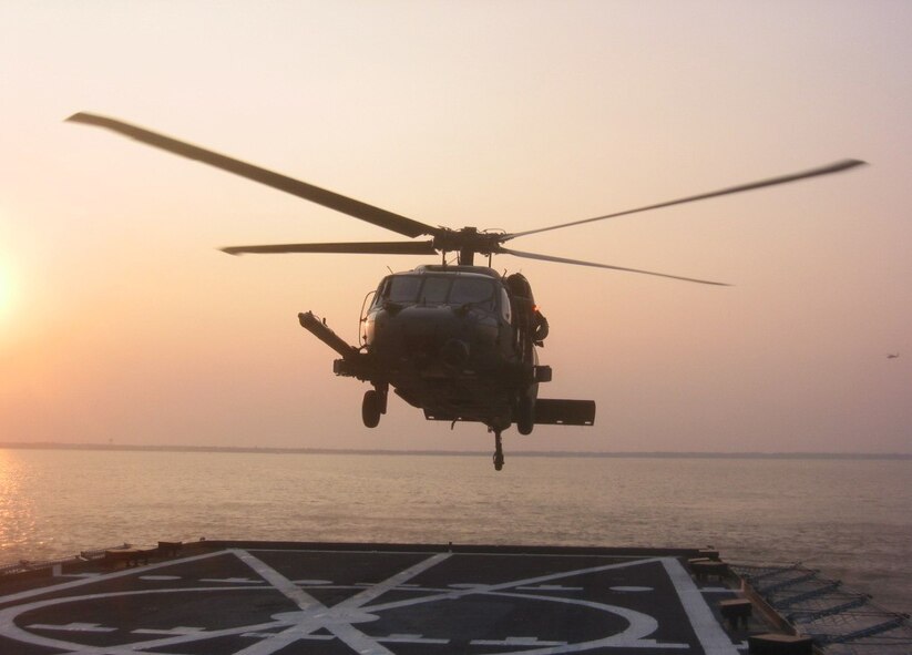 PENSACOLA BAY, Fla. - A 41st Rescue Squadron HH-60G Pave Hawk helicopter lands on the Baylander, a Navy vessel used for helicopter training, during ship boarding operations Jan. 25 and 26 at Pensacola Bay, Fla. The exercise is a mandatory training requirement for the 41st RQS, stationed at Moody Air Force Base, Ga., and improves its search and rescue capabilities. (Photo by Tech. Sgt. Mark Riensche)
