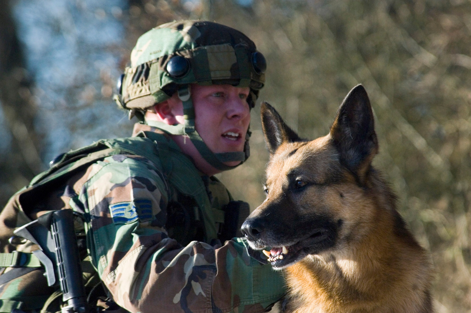 BAUMHOLDER, Germany (AFPN) -- Staff Sgt. Brandon Tillman and Allan rest after searching for improvised explosive devices during foot patrol training.  They are with the 52nd Security Forces Squadron at Spangdahlem Air Base, Germany, and participated in Creek Defender in southwestern Germany earlier this month. (U.S. Air Force photo by Master Sgt. John E. Lasky)

