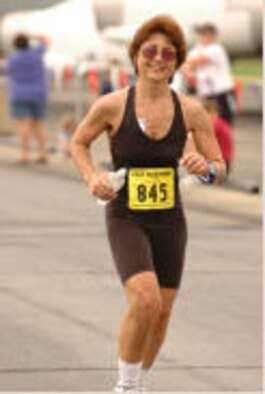 Senior Airman Christina Lindstrom dashes for the finish line during a 2005 marathon race.  Airman Lindstrom pursued her personal goal, losing nearly 50 pounds, in order to reenter the Air Force Reserve.