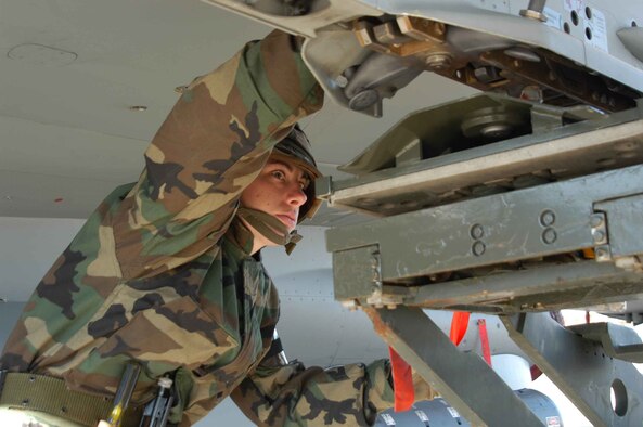 Staff Sgt. Nora Turner, 944th Aircraft Maintenance Squadron weapons load crew member, works to remove a pylon from an F-16 during an Ability to Survive and Operate exercise Feb. 12, 2006. (Photo by Staff Sgt. Stephen Razo)