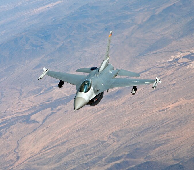 A 944th Fighter Wing (Air Force Reserve) F-16 flies over the Arizona desert Feb. 11, 2006. (Photo by John Fuchs)