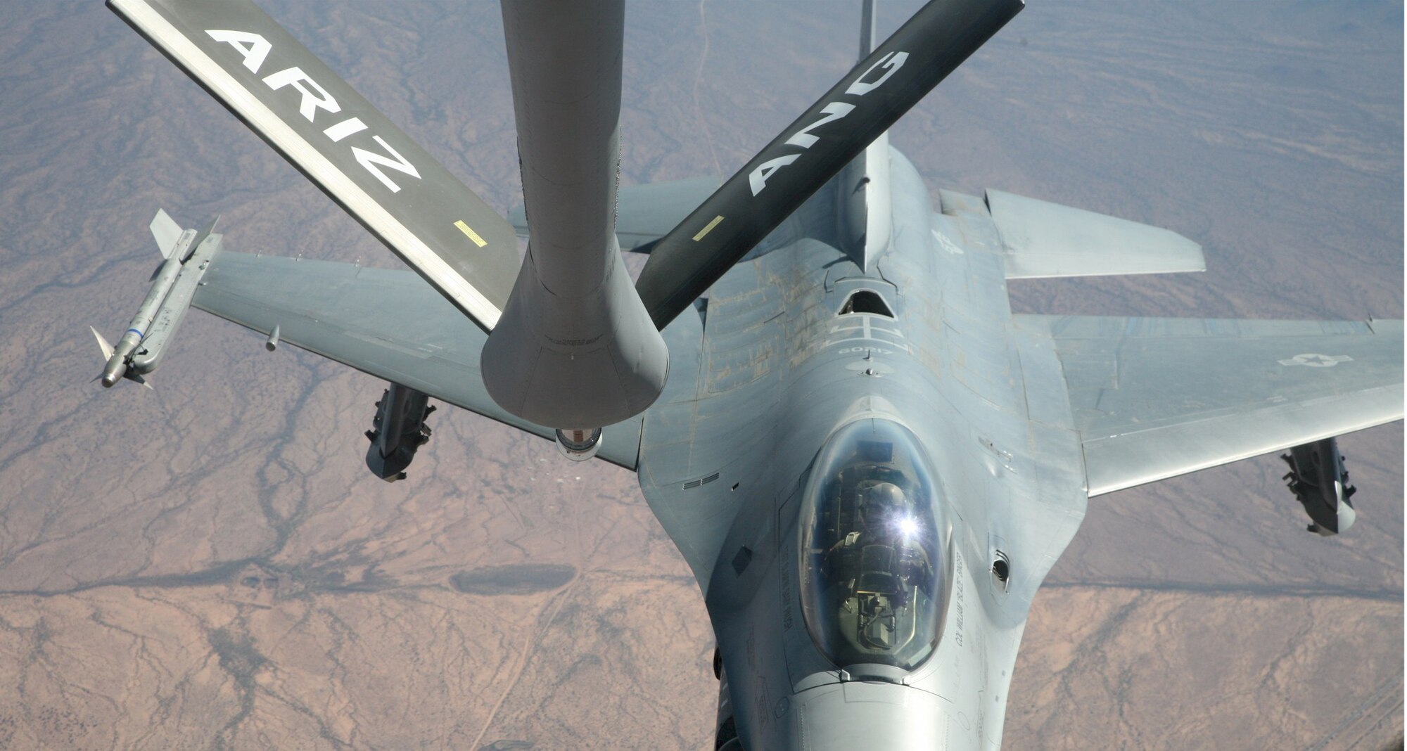 A 944th Fighter Wing (Air Force Reserve) F-16 refuels from an Arizona Air National Guard KC-135 from the 161st Aerial Refueling Wing during a refueling mission Feb. 11, 2006. The 161st ARW refueled four of the 944th Fighter Wing's F-16s during Bosses Day. (Photo by John Fuchs)