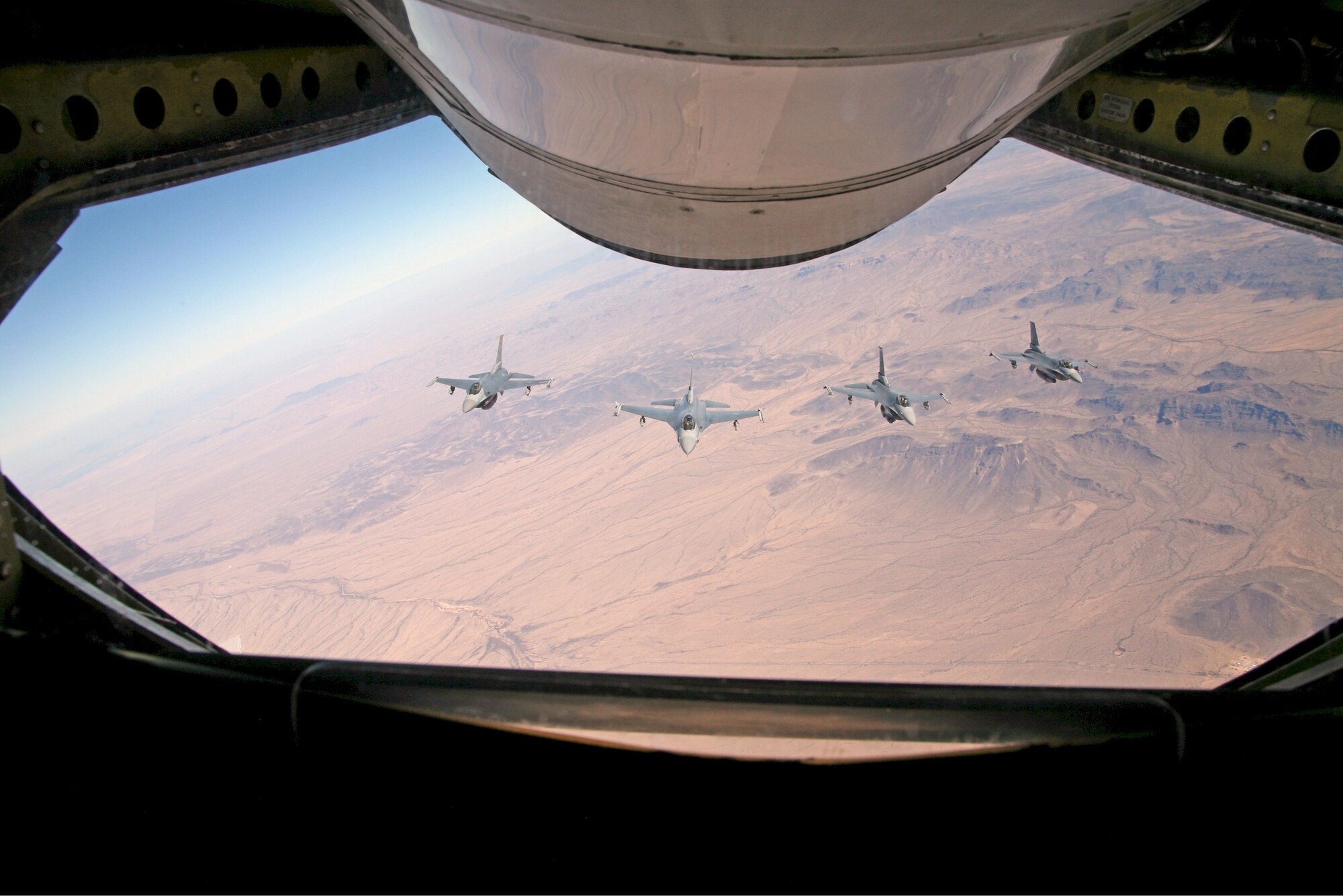 Four 944th Fighter Wing (Air Force Reserve) F-16s behind an Arizona Air National Guard KC-135 from the 161st Aerial Refueling Wing during a refueling mission Feb. 11, 2006. The 161st ARW refueled four of the 944th Fighter Wing's F-16s during Bosses Day. (Photo by John Fuchs)