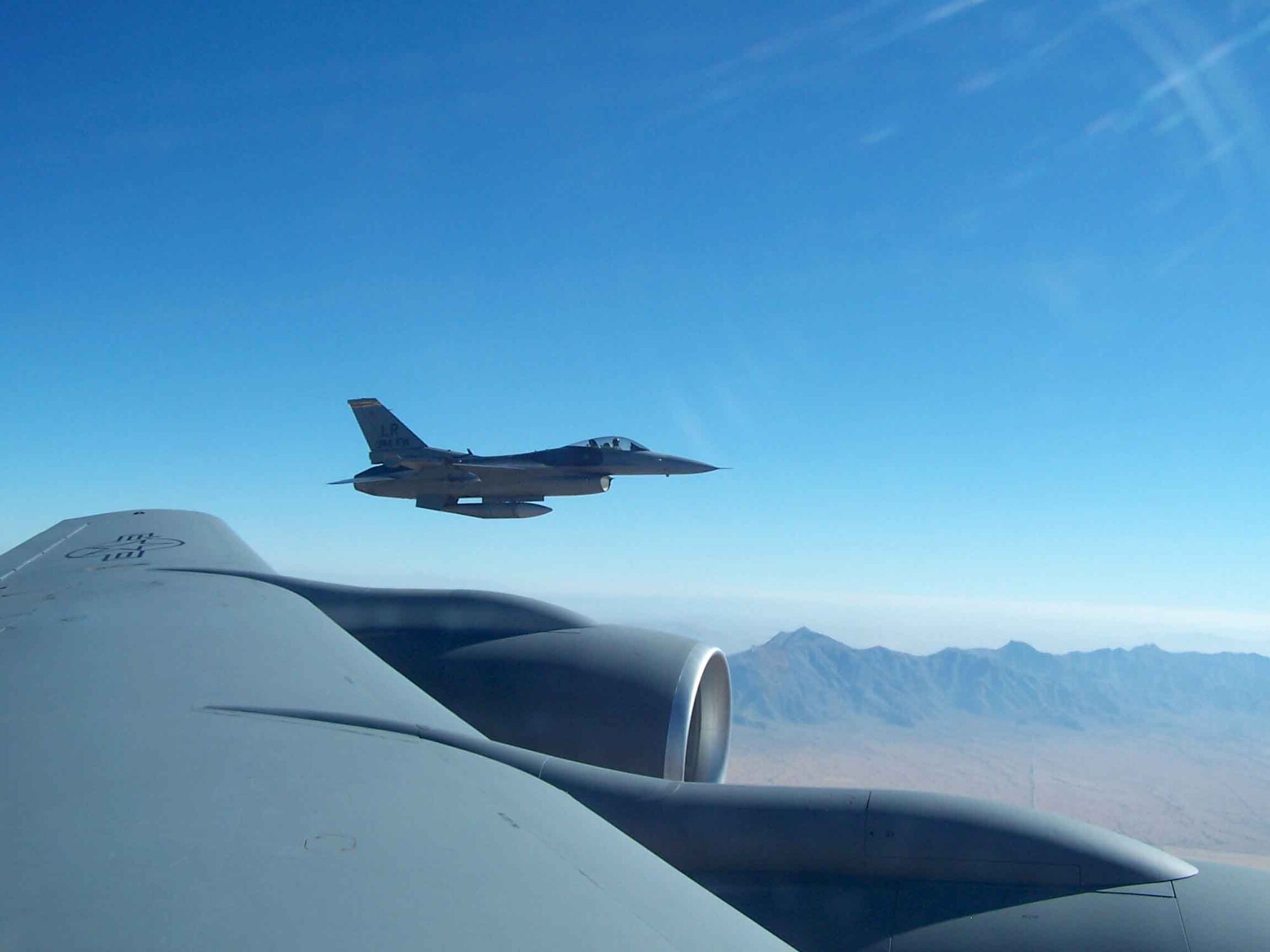 A 944th Fighter Wing (Air Force Reserve) F-16 flies off the wing of an Arizona Air National Guard KC-135 from the 161st Aerial Refueling Wing during a refueling mission Feb. 11, 2006. The 161st ARW refueled four of the 944th Fighter Wing's F-16s during Bosses Day. (Photo by Master Sgt. Elizabeth Barker)