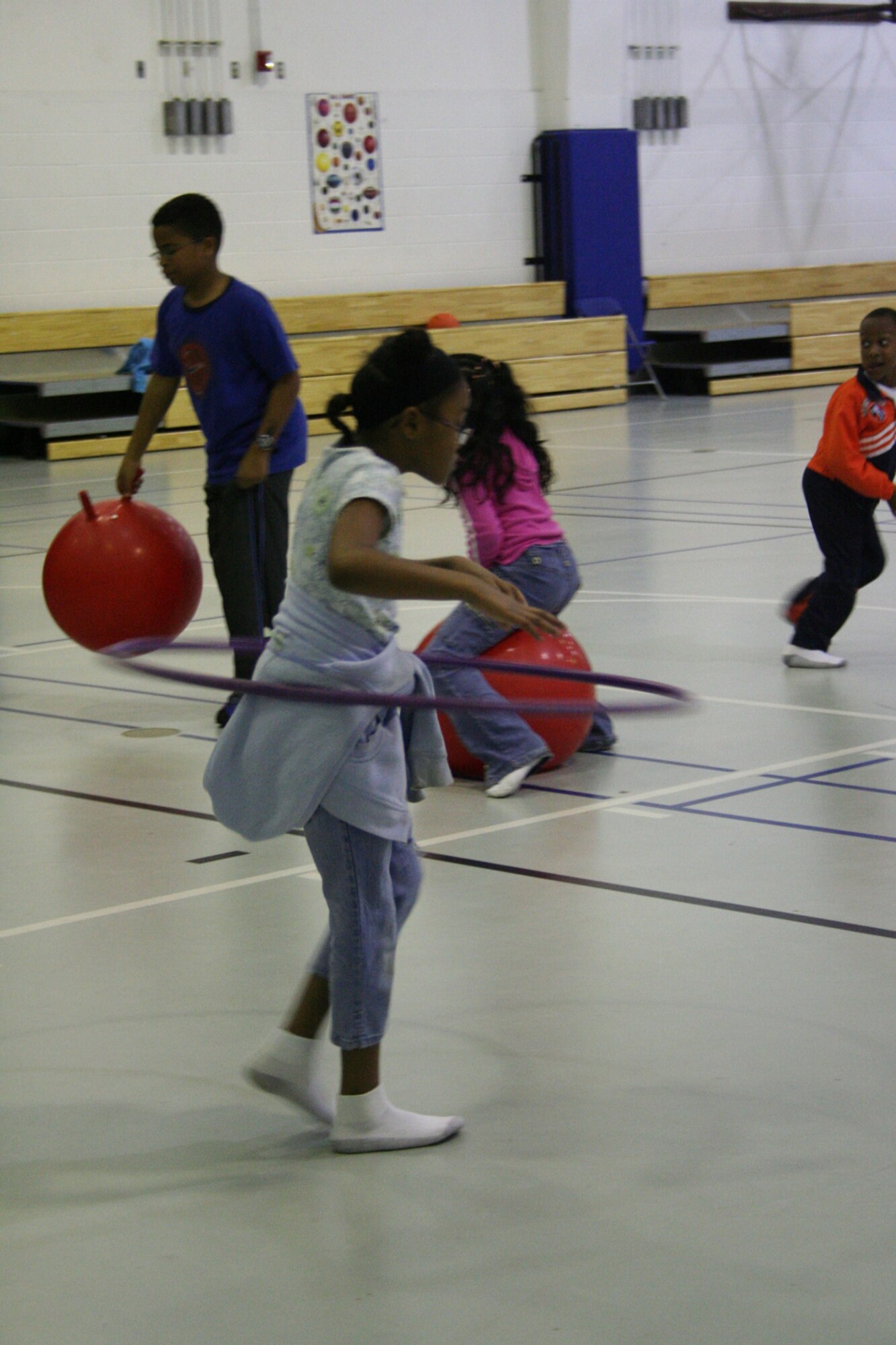 Indya Drew hula hoops her way across the gym floor at the Hurlburt Field youth center 