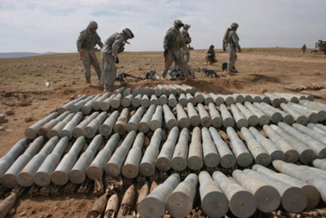 Soldiers from the U.S. Armyís 4th Squadron, 14th Cavalry Regiment, line up mortar shells, anti-tank, anti-personnel, and anti-aircraft rounds found in a weapons cache near Rawah, Iraq, on Feb. 20, 2006. The munitions will be destroyed in order to prevent their use by insurgents in improvised explosive devices. 