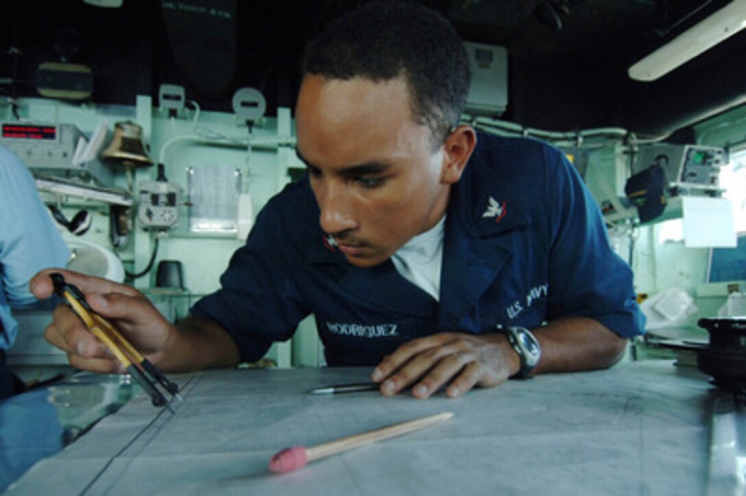 U.S. Navy Petty Officer 3rd Class Carlos Rodriguez plots his ship's position on a navigation chart on the bridge of the USS Carter Hall (LSD 50) during a underway replenishment with the Military Sealift Command oiler USNS Rappahannock (T-AO 204) in the Persian Gulf on Feb. 16, 2006. Carter Hall is conducting maritime security operations in the Gulf region as part of the USS Nassau (LHA 4) Expeditionary Strike Group. Rodriguez is a Navy quartermaster on board the Carter Hall. 