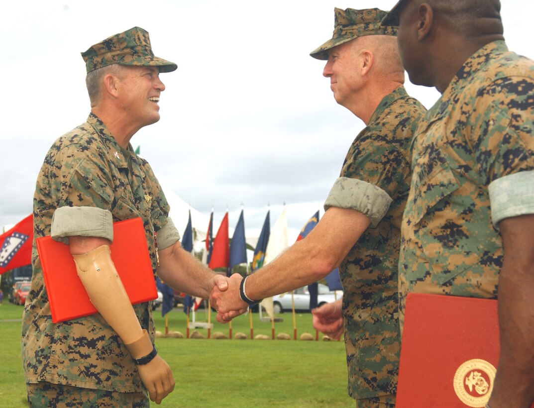 Gunnery Sgt. Robert Grogan, administration chief, Headquarters & Services Company, Battalion Landing Team 1st Battalion, 4th Marine Regiment, 11th Marine Expeditionary Unit, (Special Operations Capable) Camp Pendleton, Calif., poses in front of the U.S.S. Ogden during a weekend of liberty on the Island of Oahu, Hawaii, Feb. 26, 2006, during their six-month deployment in support of the Global War on Terrorism.