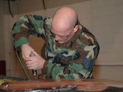 Tech. Sgt. Charles Spruill, a reservist assigned to the 315th Maintenance Squadron, Charleston AFB, S.C., preformas maintenance on a C-17 Globemaster III aileron.  Sergeant Spruill is a traditional reservist performing his required 2-weeks of annual tour. (Photo by Tony Clark, USAFR)