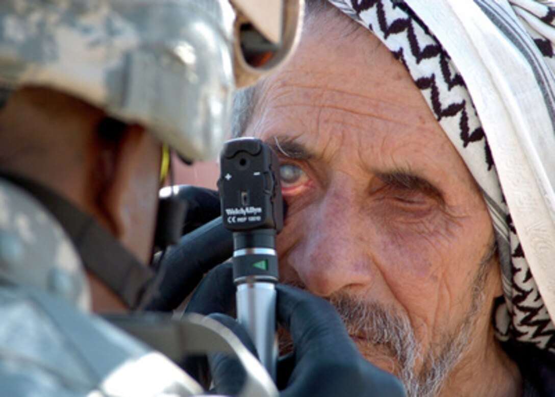 U.S. Army Capt. Edward Barnes examines an Iraqi man's eyes during a community health outreach program in Rushadah, Iraq, on Feb. 23, 2006. Barnes is a battalion surgeon for the 66th Armor Battalion, 1st Brigade, 4th Infantry Division. 