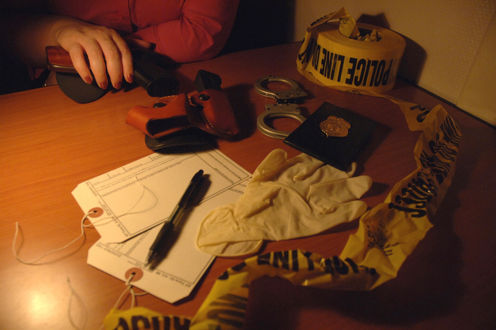 An OSI agent with some of the tools of the trade. (U.S. Air Force photo illustration/Staff Sgt. Joshua Strang)