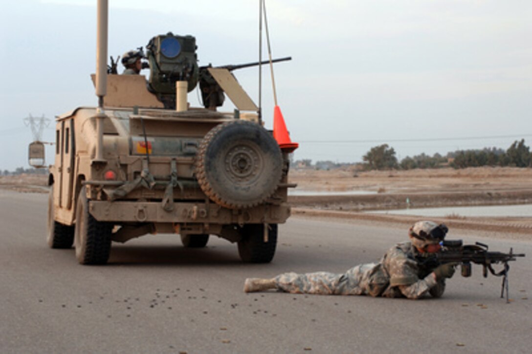 Brass shell casings lie scattered in the road as U.S. Army soldiers from Alpha Troop, 1st Battalion, 75th Cavalry Squadron, 101st Airborne Division, provide security after an altercation in Baghdad, Iraq, on Feb. 22, 2006. 