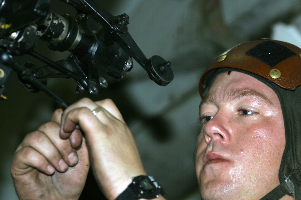 ABOARD THE USS PELELIU (March 3, 2006)- Cpl. Brandon M. Kinsley, a collateral duty inspector, flight line section of the Marine Medium Helicopter Squadron 166, Marine Corps Air Station Miramar, San Diego, from Lackawanna, N.Y., installs a tail rotor crosshead on a UH-1N Huey for a phase inspection Feb. 28.  The phase inspection is required on all hueys every 200 flight-hours. The Marines and sailors of HMM-166, as part of 11th Marine Expeditionary Unit (Special Operations Capable) Camp Pendleton, Calif., are currently on a six-month deployment to the Western Pacific and Arabian Gulf aboard the Peleliu in support of the Global War on Terrorism.