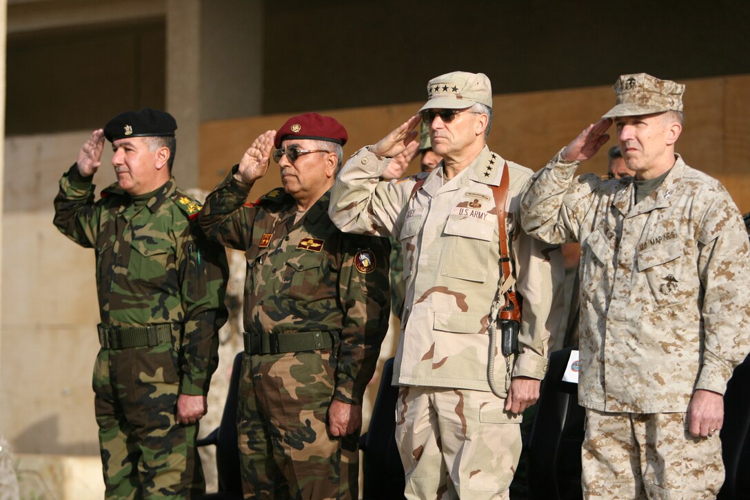 At a transfer-of-authority ceremony at Camp Fallujah, Iraq, (from left to right) Army Gen. George W. Casey Jr., commanding general of Multi-National Force -- Iraq, Maj. Gen. Richard A. Huck, commanding general of 2nd Marine Division and II Marine Expeditionary Force (Forward), Maj. Gen. Dhaher Ali Ahmed, 1st Iraqi Army Division commanding general, and Brig. Gen. Murthi Rafa, 7th Iraqi Army Division commanding general, salute the Iraqi and American National Anthems.